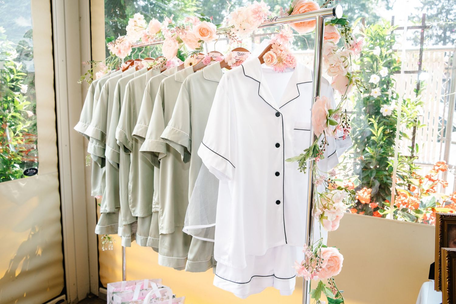 White robes hang on display at an elegant bridal shower venue.