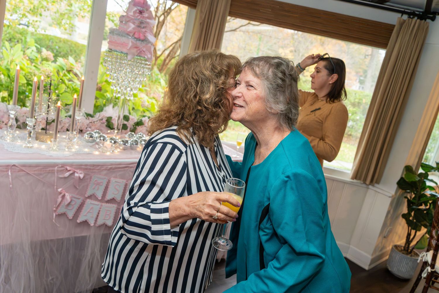 Party guests interact and celebrate at an indoor social gathering.