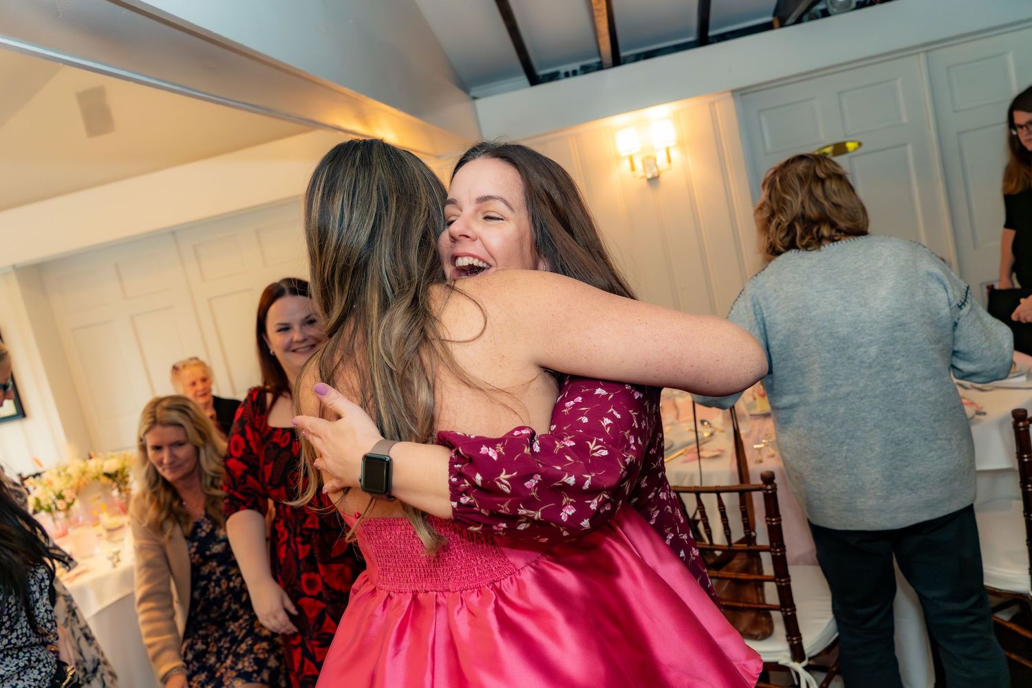 People dancing and celebrating at an indoor party venue.