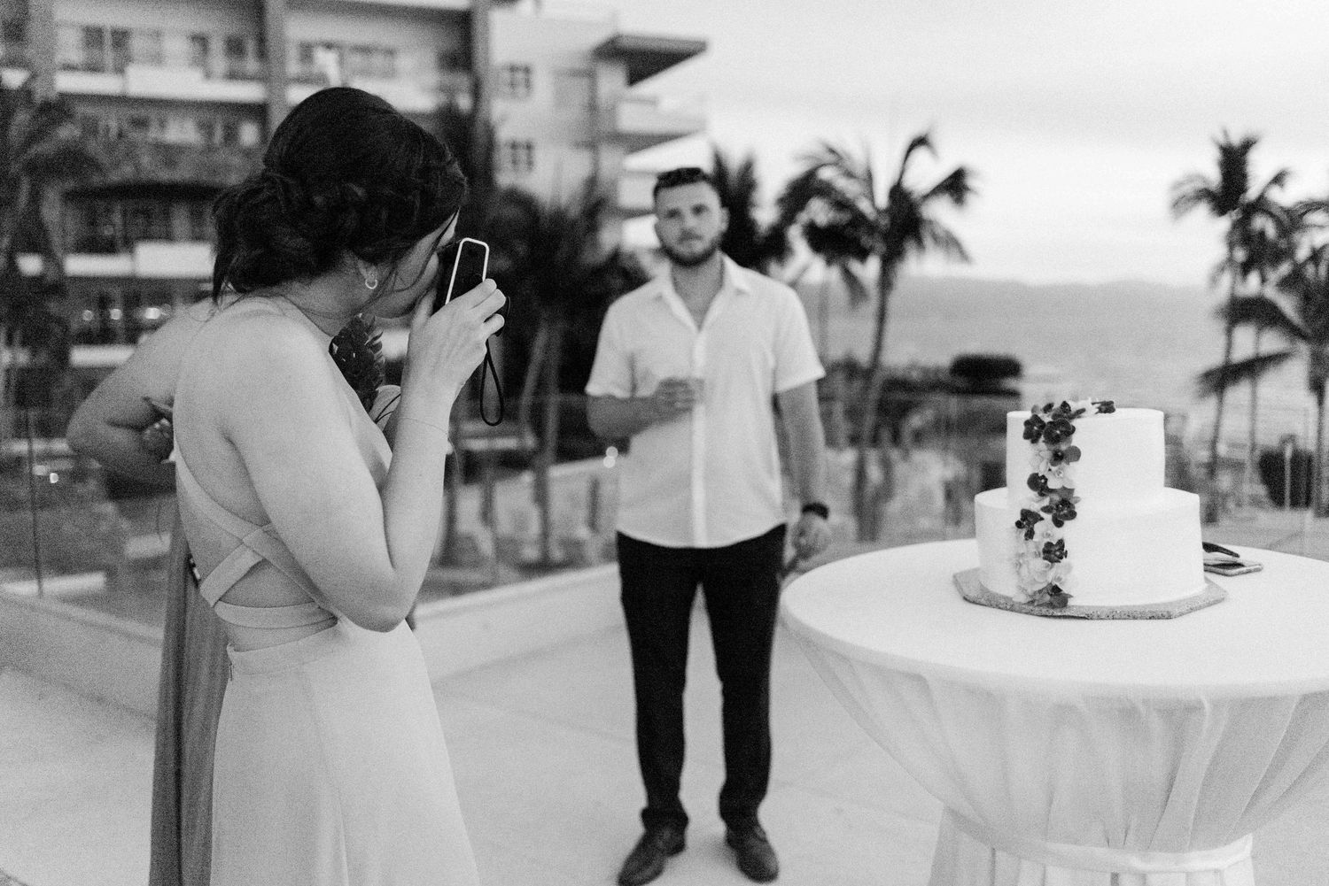 Candid black and white photo of special moment with wedding cake.