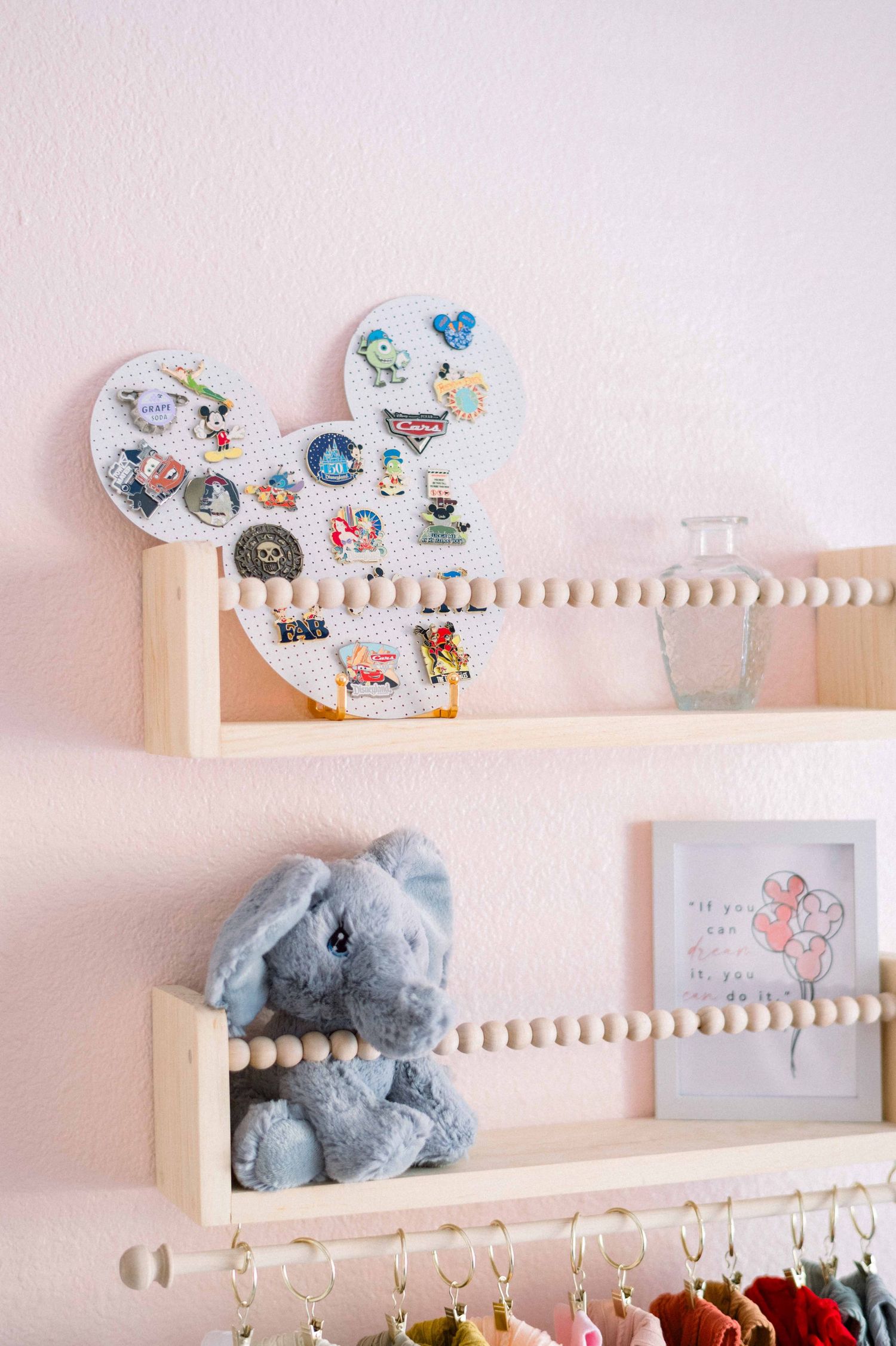Mickey Mouse-shaped shelf displaying Disney collectibles and a plush elephant toy.