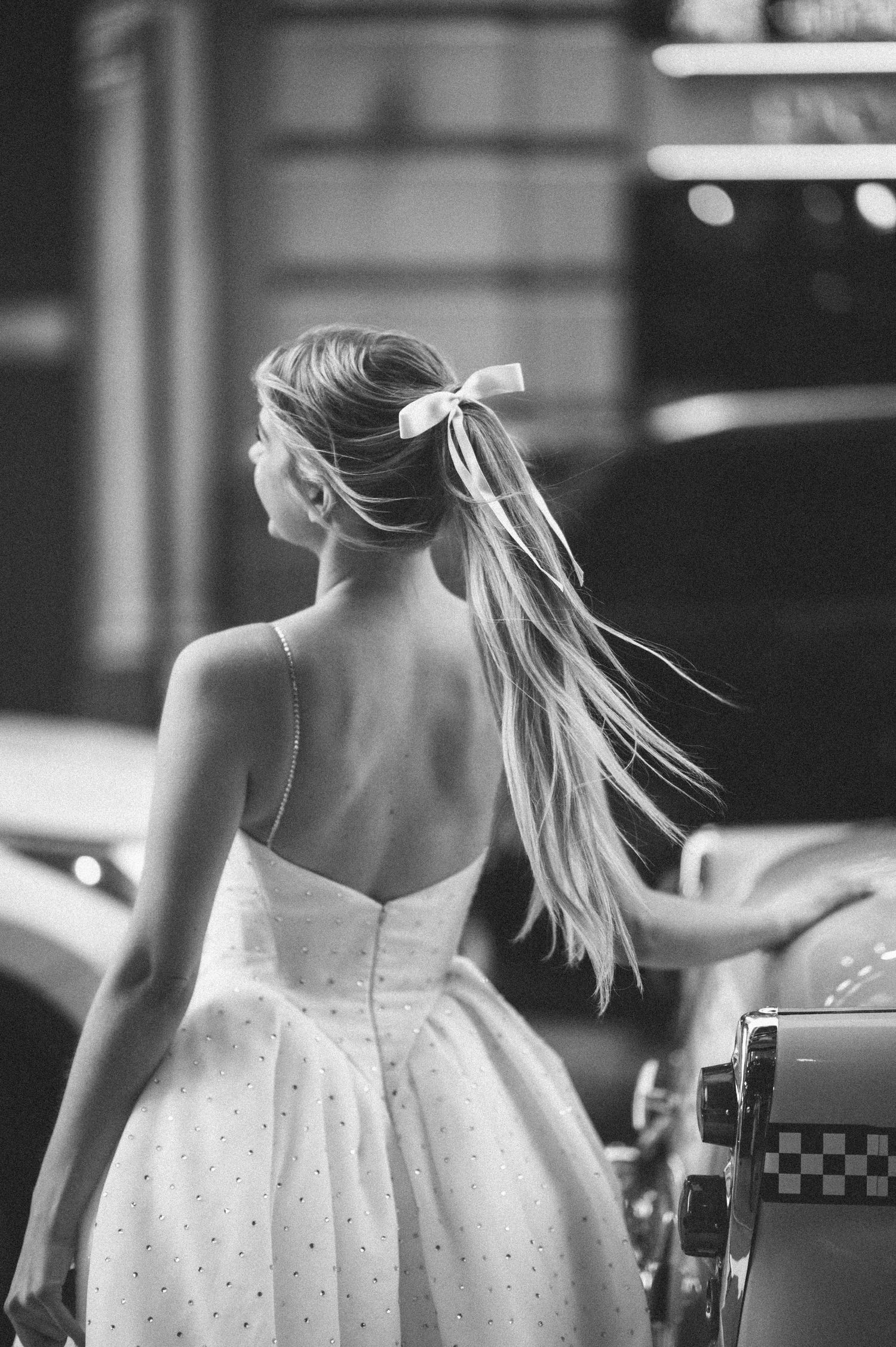 Black and white portrait series showing details of a polka dot dress from behind.