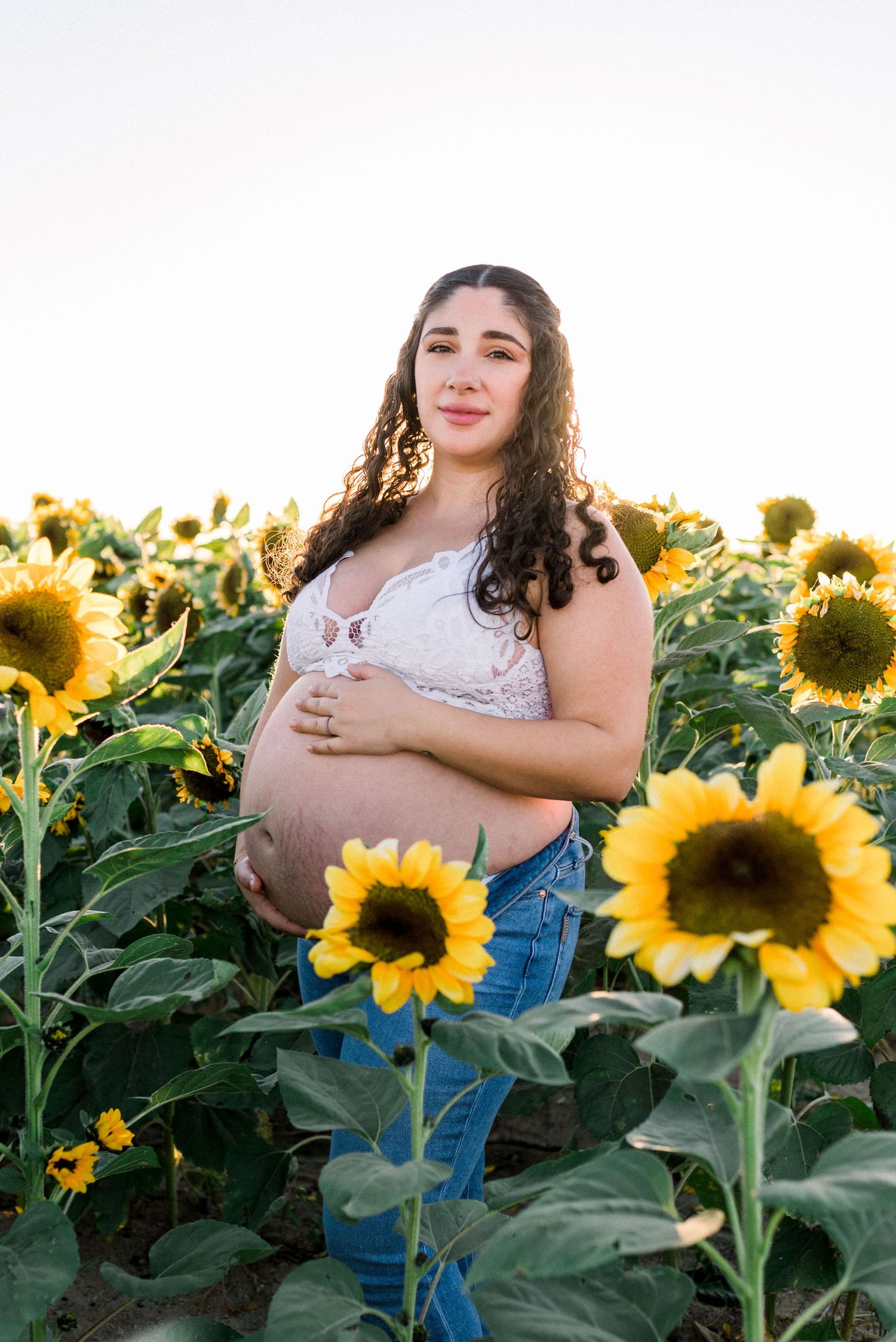 Photo of pregnant woman in sunflower field