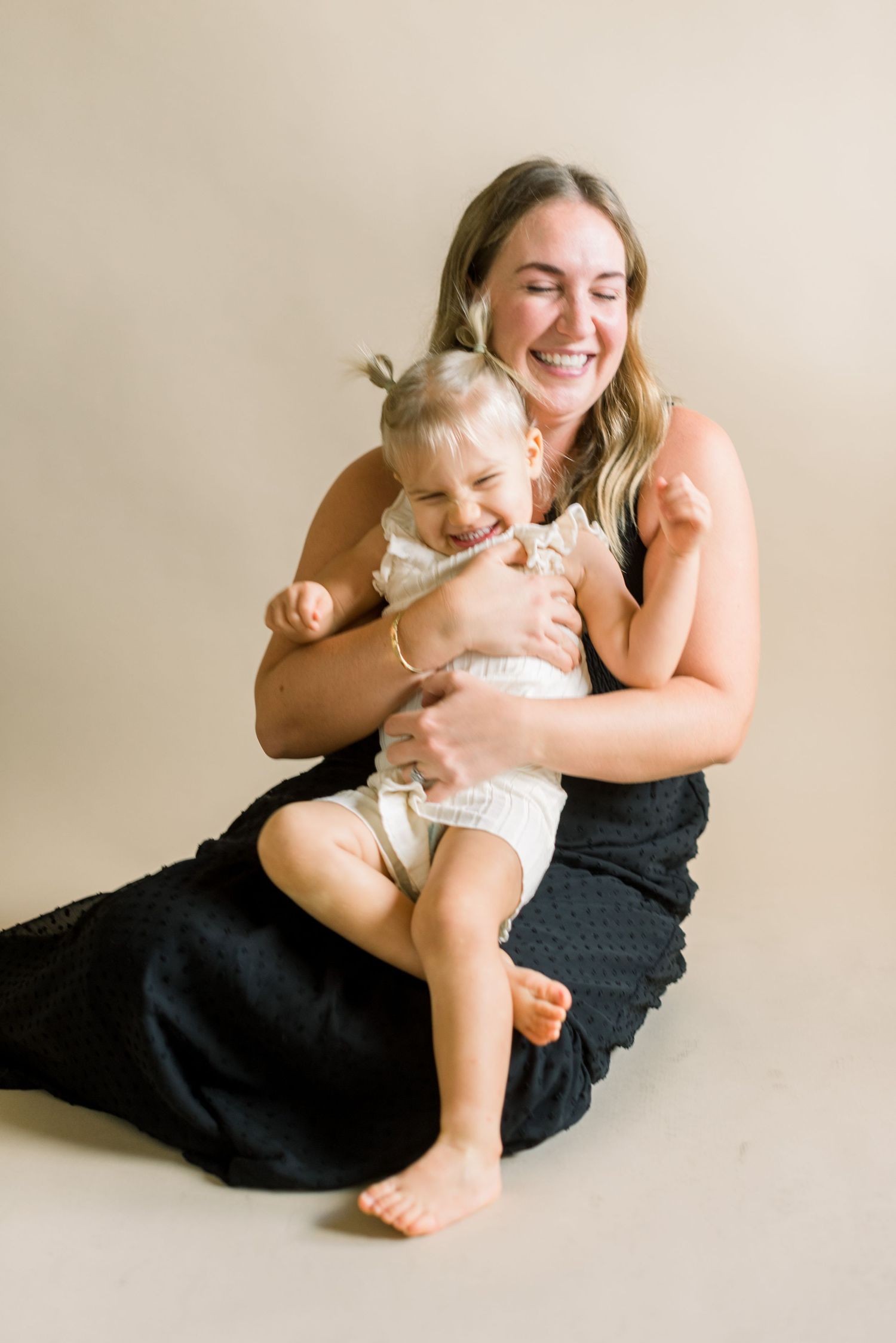 An intimate portrait showing tender embraces and genuine smiles during a photo session.