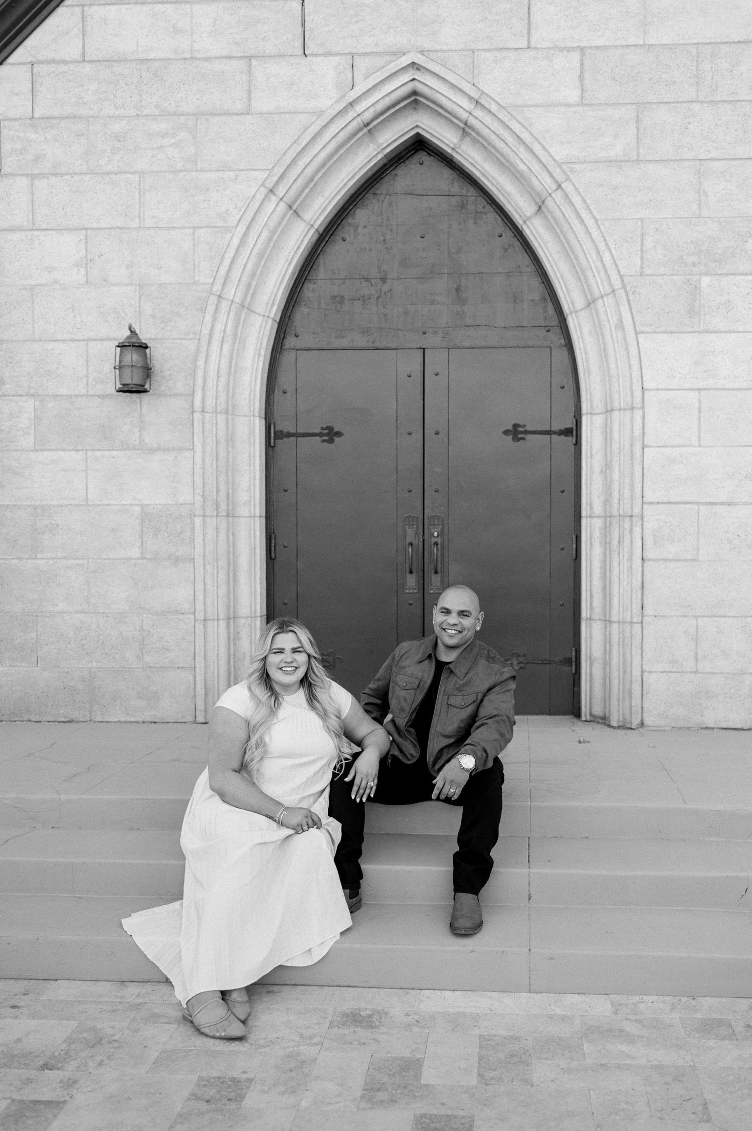 Gothic stone church entrance with arched doorways and architectural details.