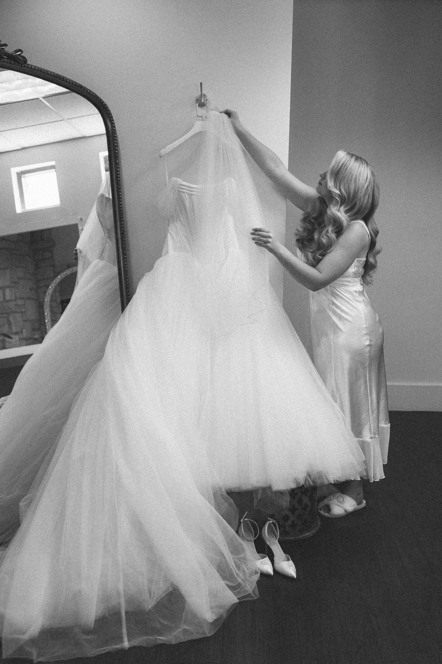 Black and white photo series showing the flowing movement of a white wedding dress being twirled and spun in motion.