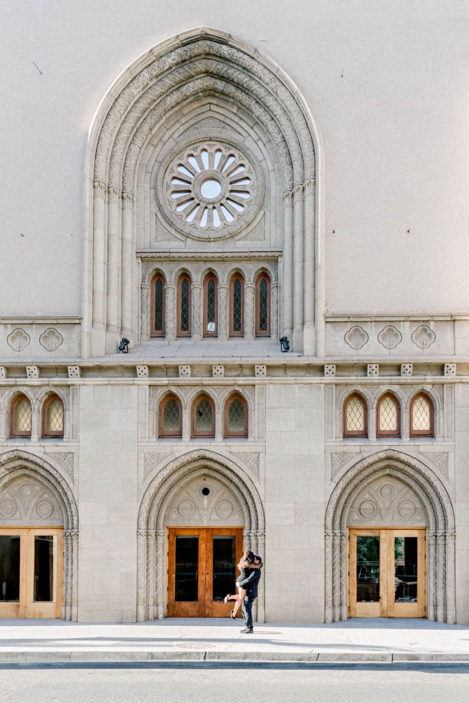 Gothic-style building exterior with arched windows and ornate sunburst design.
