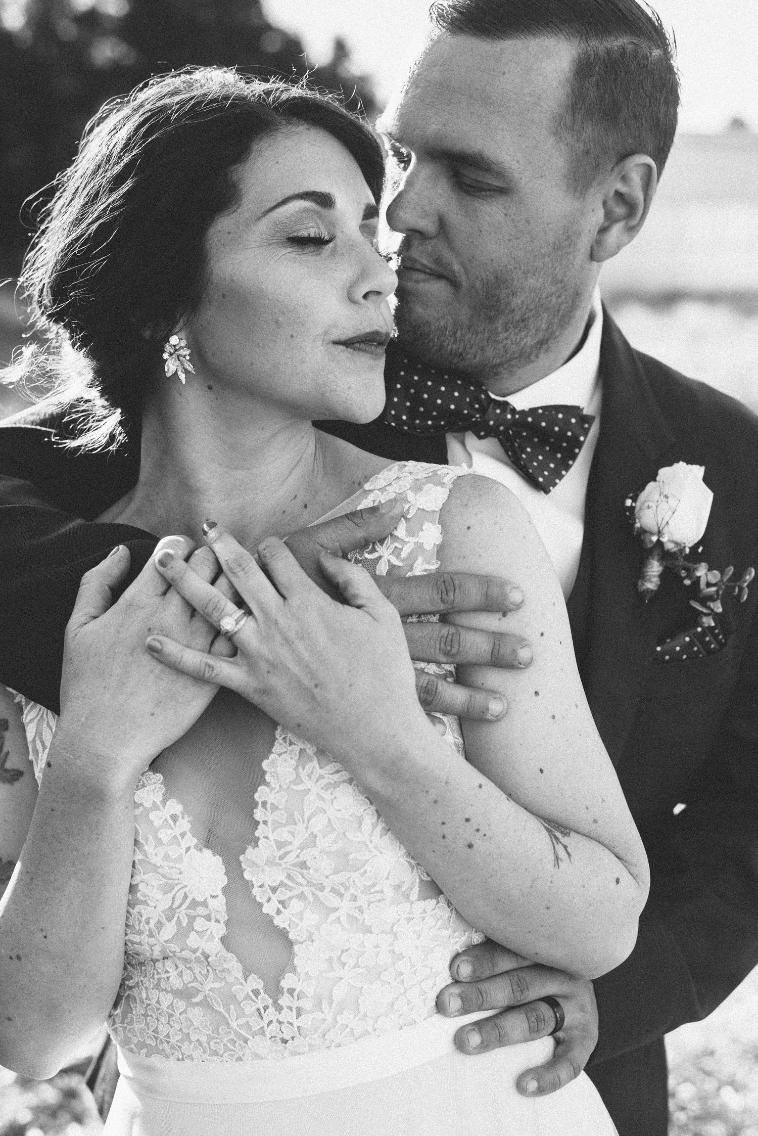 Intimate black and white portrait of newlyweds sharing a romantic moment.