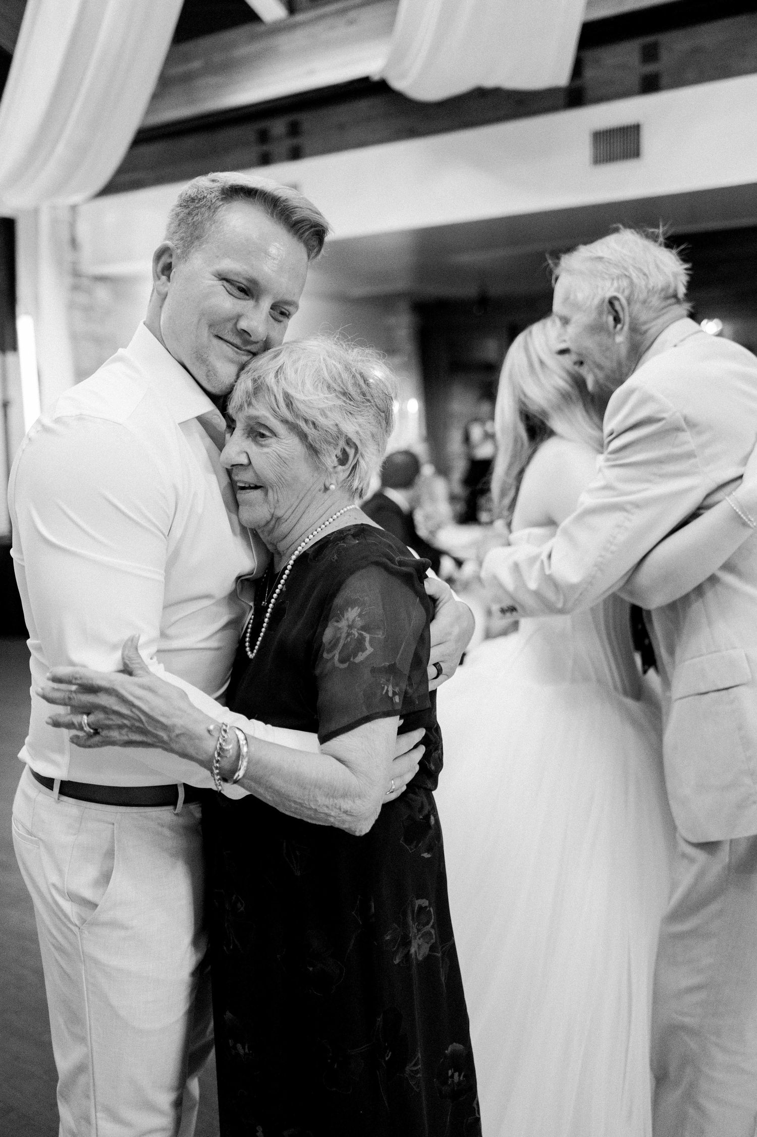 Elderly couples dancing together in formal attire at what appears to be a social gathering or dance event.