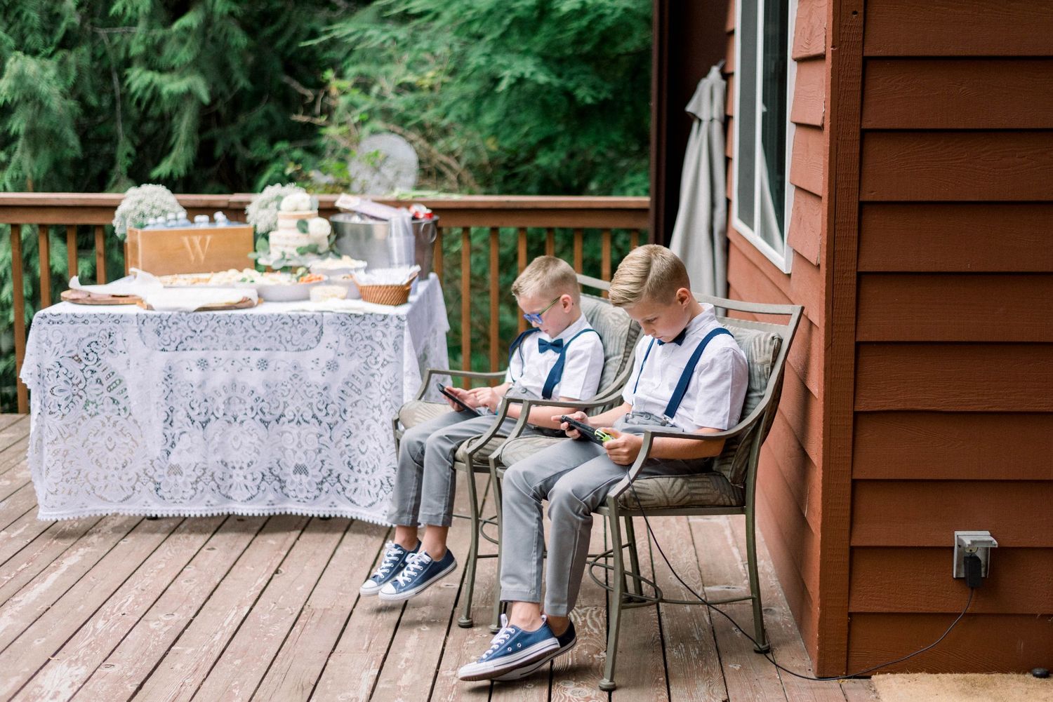 Patio scene with lace tablecloth and chairs on rustic cabin deck.