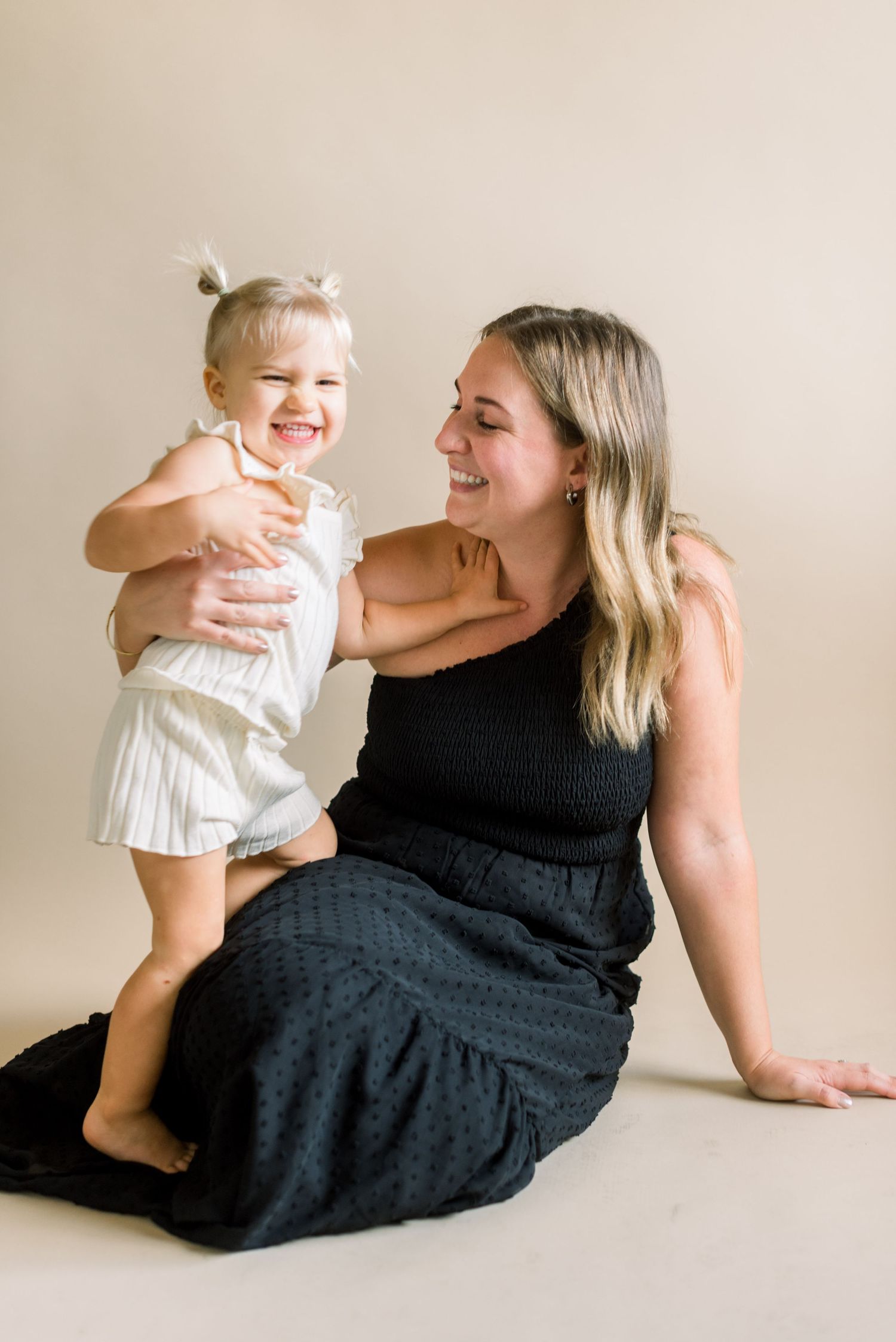 A joyful lifestyle portrait showing genuine laughter and connection between two people.
