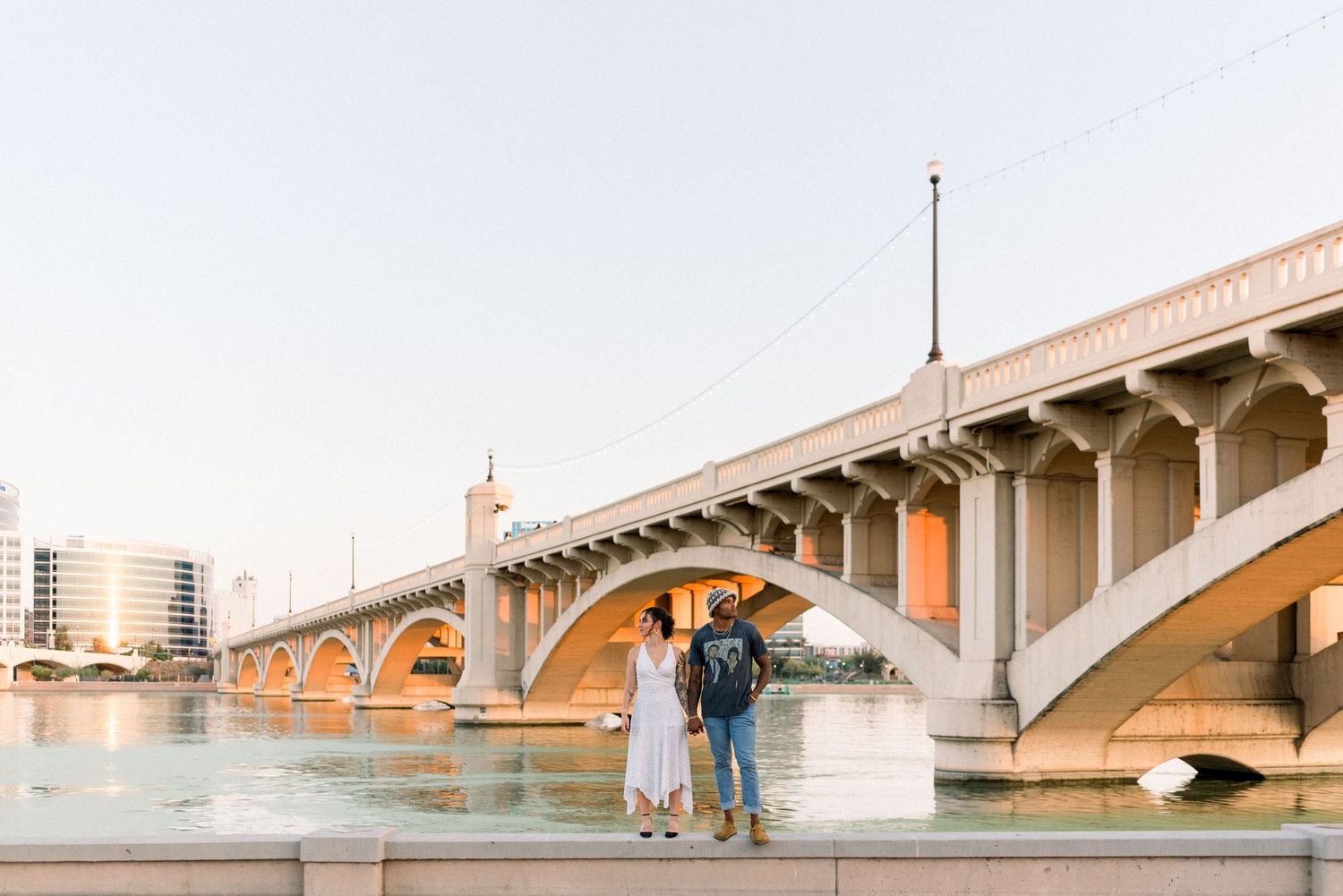 A series of five connected photos showing different angles of a concrete bridge with arches over water at sunset.