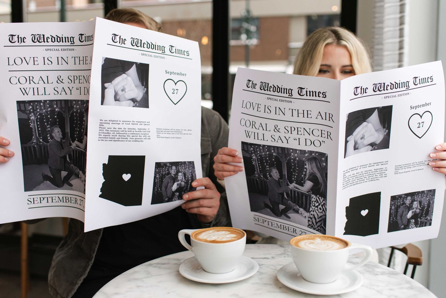 Two custom wedding newspapers displayed at a cafe table with coffee cups.