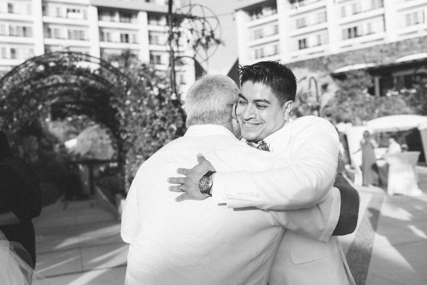 A touching black and white moment captured during a wedding celebration.