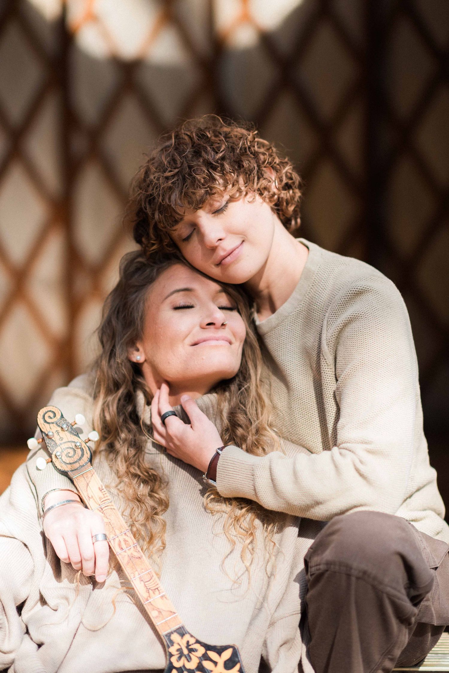 Close embrace captured in natural light inside rustic yurt structure.