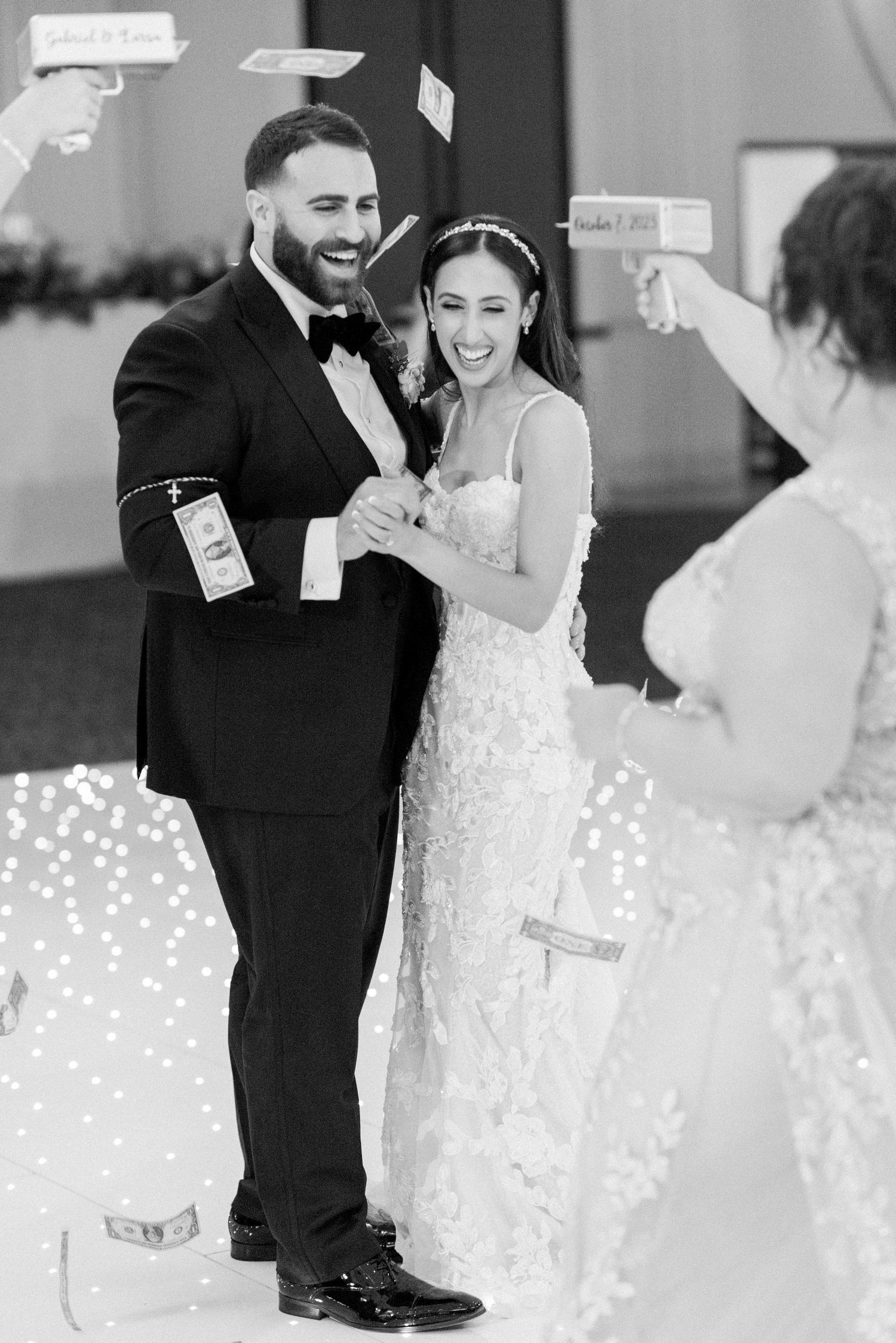 A black and white wedding celebration with dancing and sparklers creating a magical atmosphere.