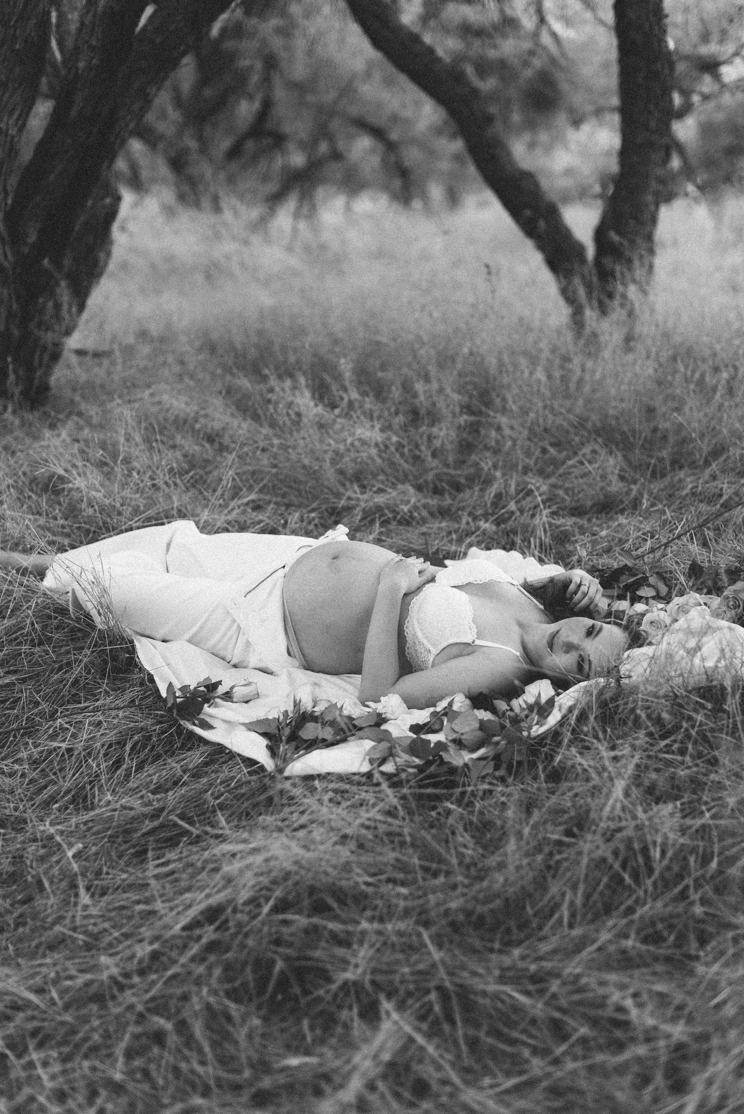 Black and white maternity photo showing peaceful moment in nature.