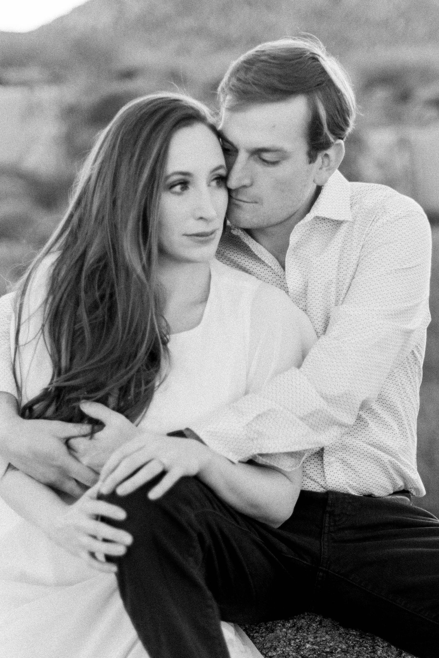 Close-up black and white engagement photo capturing a tender moment between a couple.
