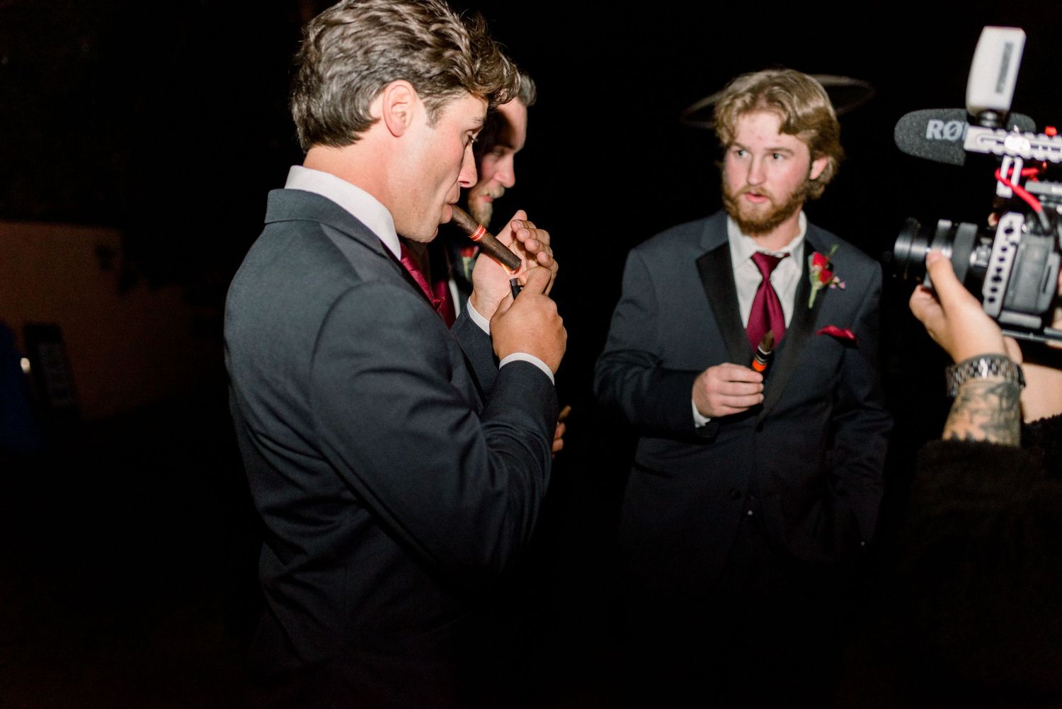 Wedding guests enjoying nighttime celebration with camera equipment visible.