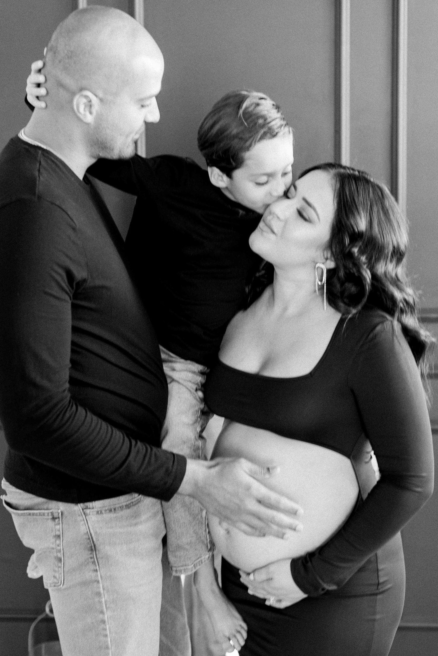 A romantic black and white photo sequence shows a couple in matching black outfits sharing tender moments together.