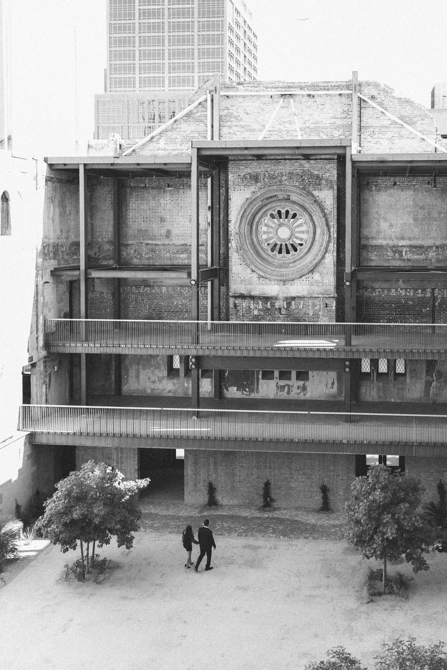 Black and white photo of historic building facade with circular window design.
