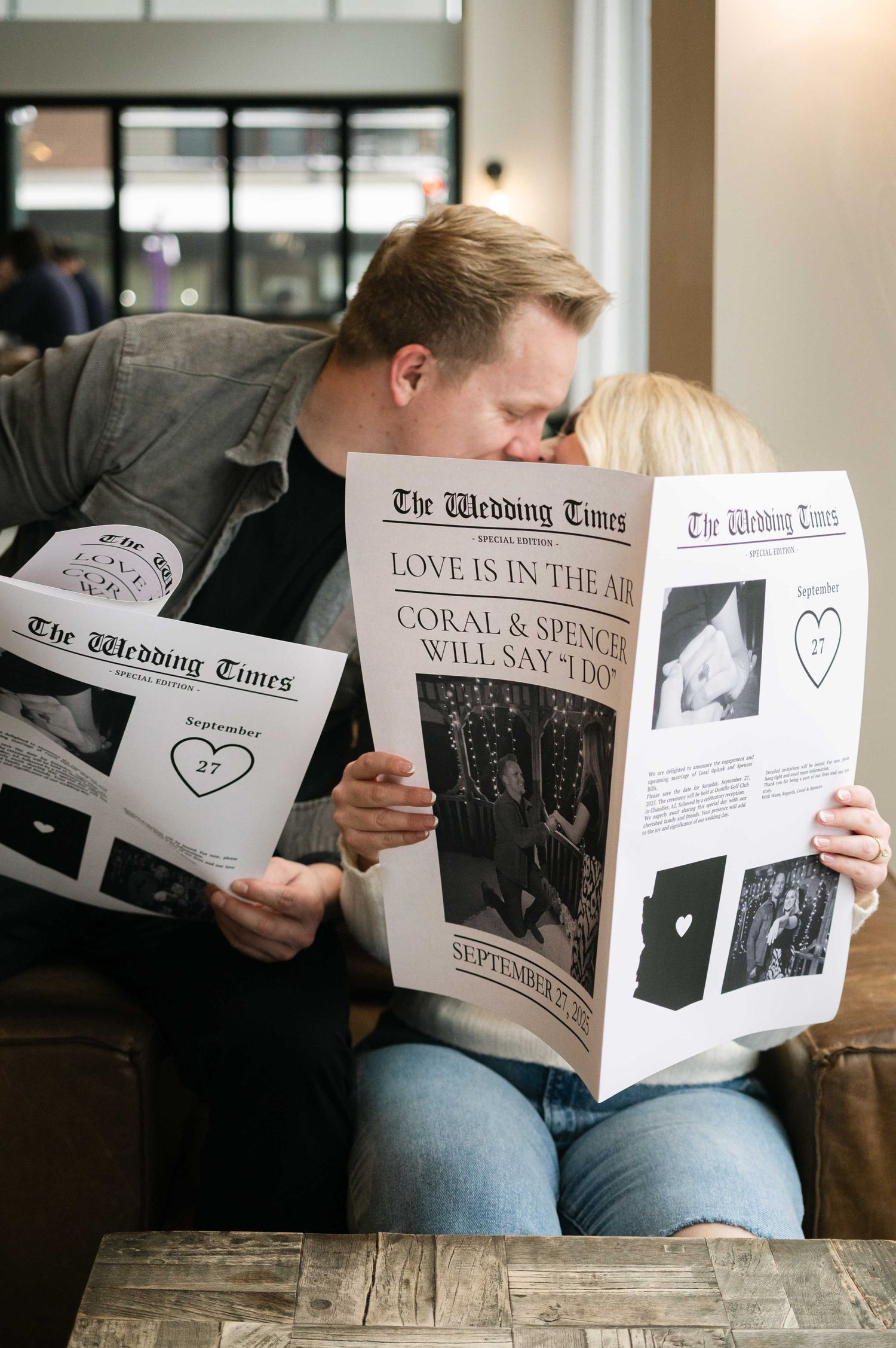 Two people share a romantic moment while reading The Wedding Times newspaper.