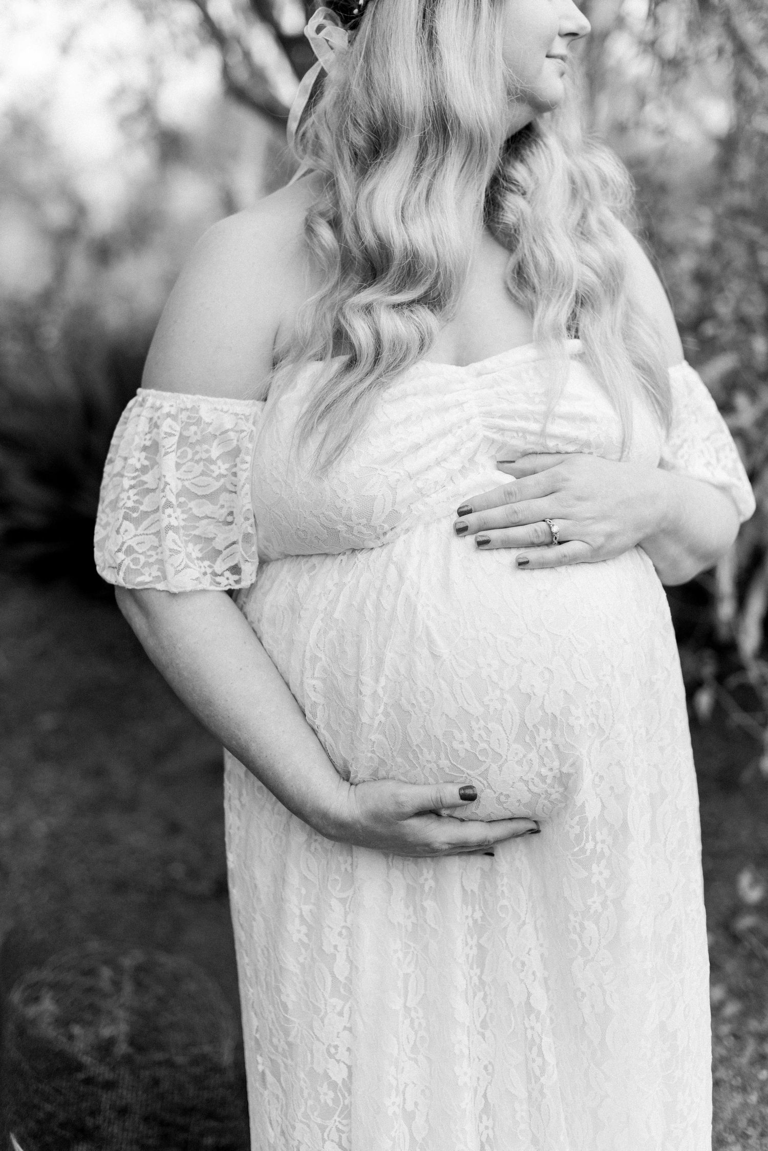 Black and white maternity portrait showcasing delicate lace details and gentle poses.