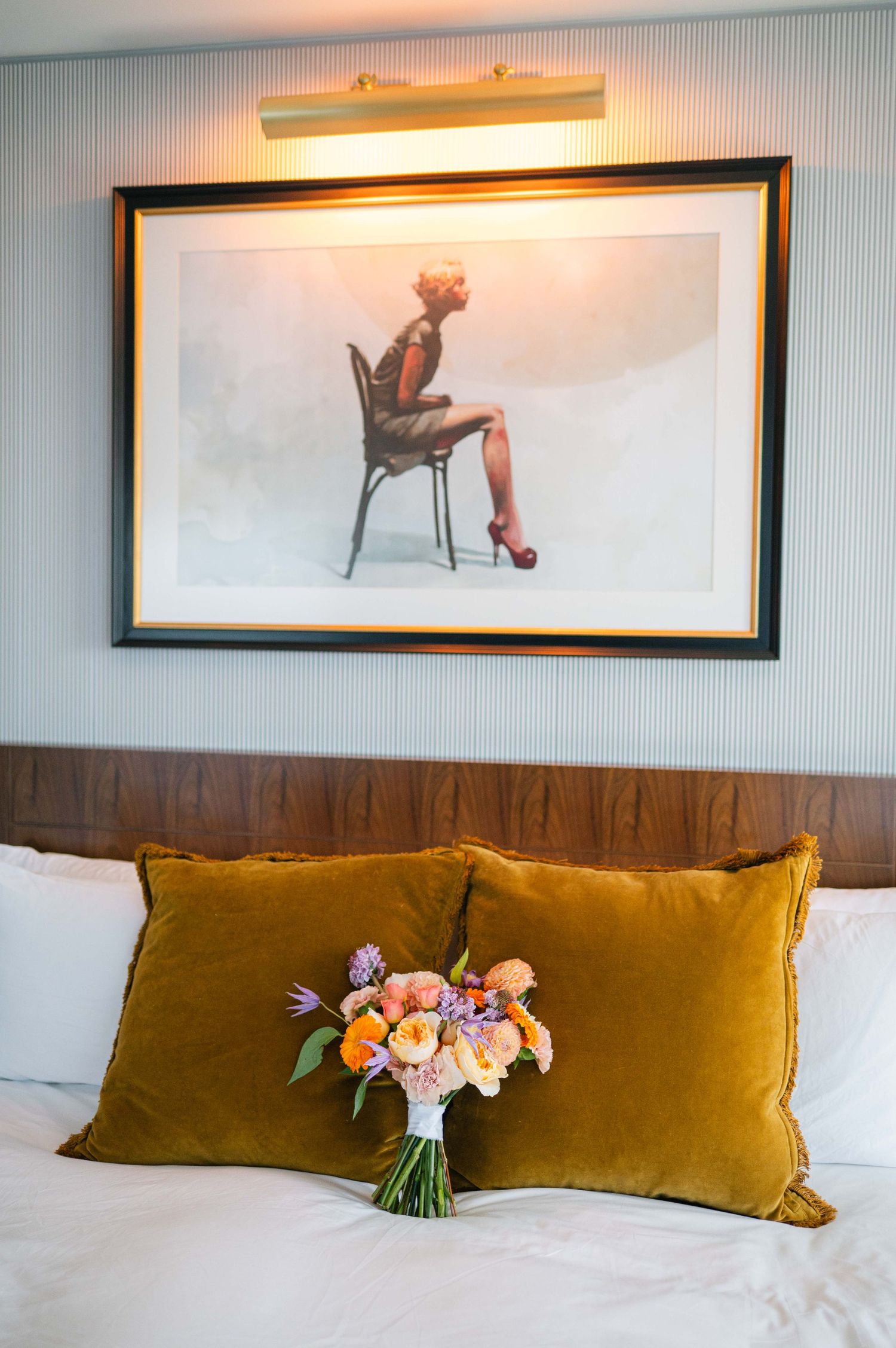 A series of photos showing a brown velvet pillow and floral bouquet arrangement on a white bed.