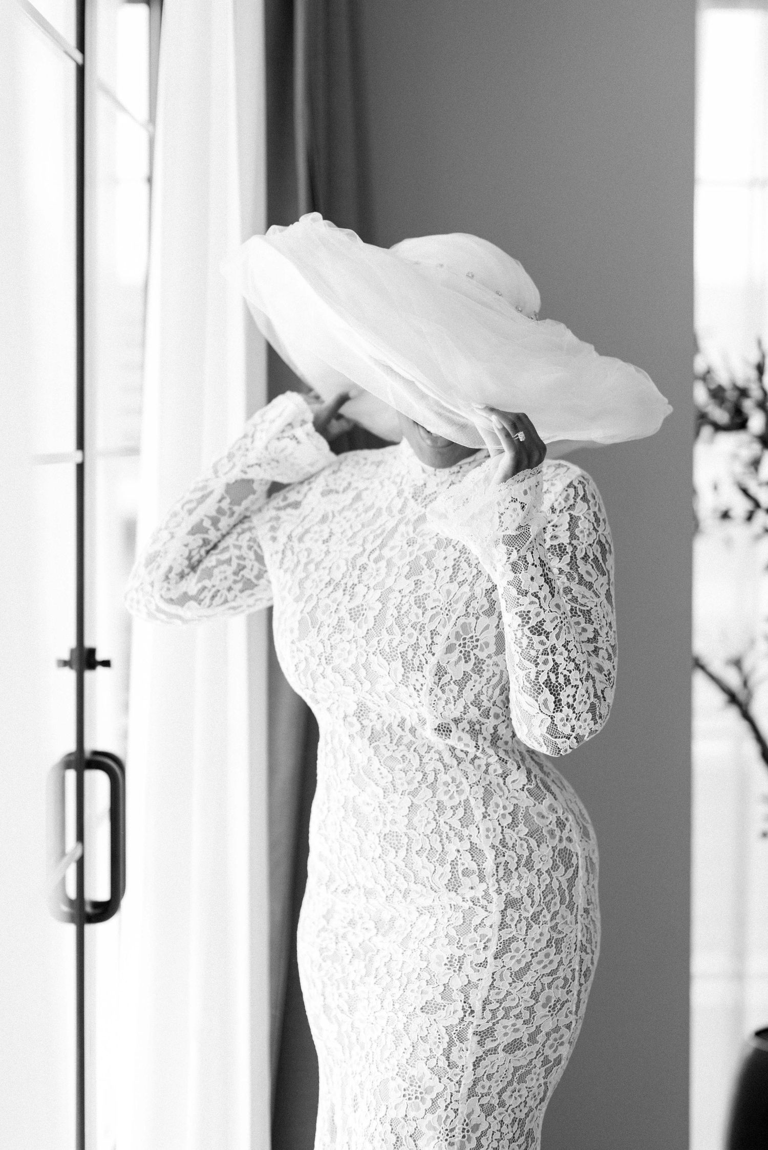 Close-up details of delicate white lace wedding dress bodice with intricate patterns.