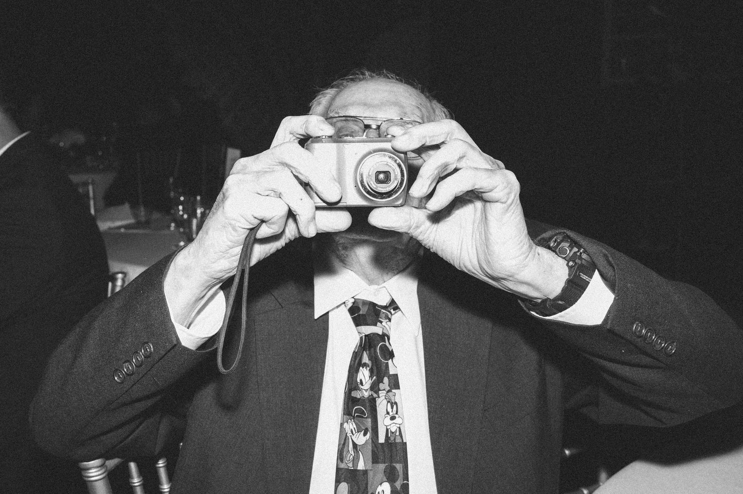 Series of black and white photos showing vintage cameras being held.