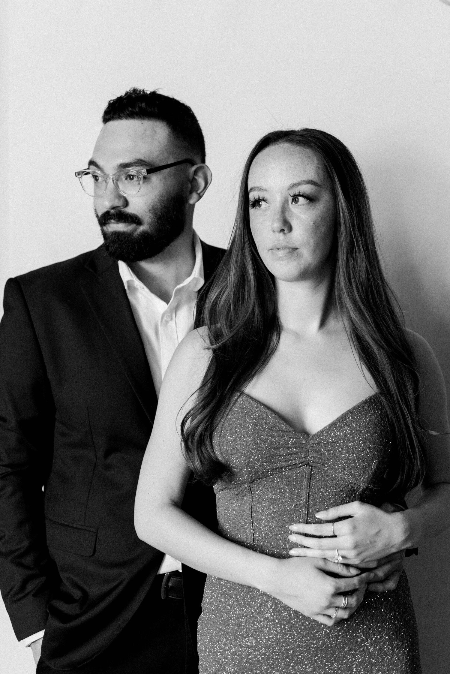Formal black and white portrait of a couple in elegant evening attire.