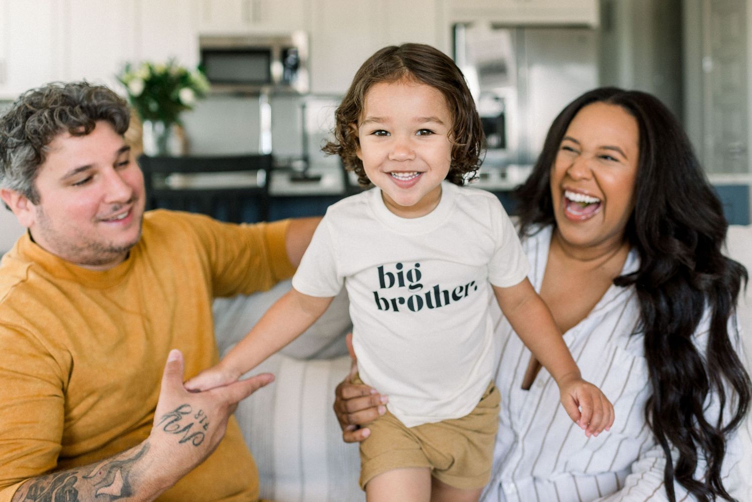 happy smiling family with pregnancy announcement