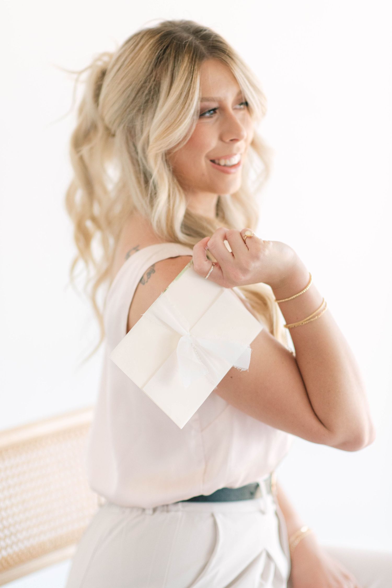 A series of bright, airy portraits showing a person in white clothing against a light background.