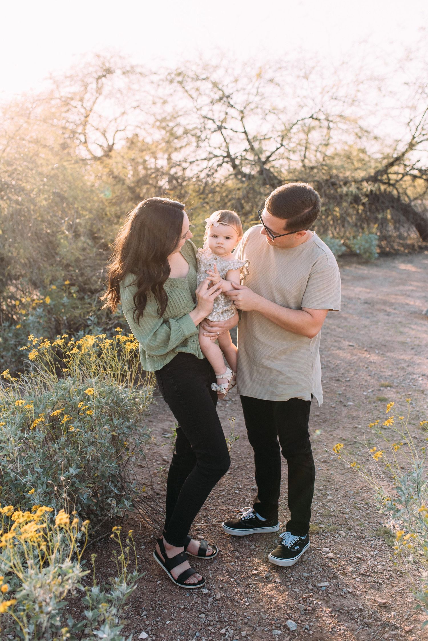 Family enjoying time together on desert path with golden sunlight.