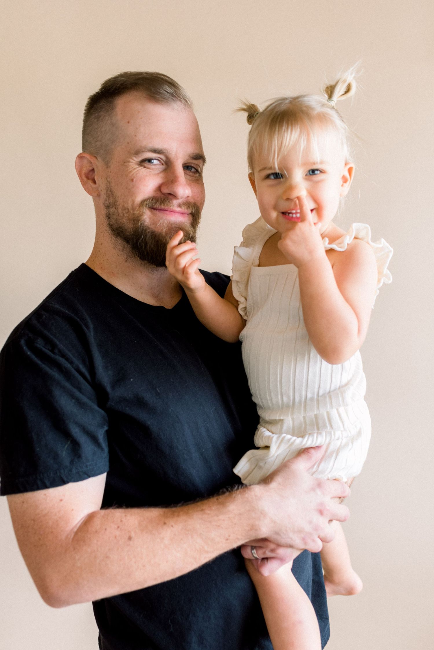 Sweet candid moment between parent and child during indoor photo session.