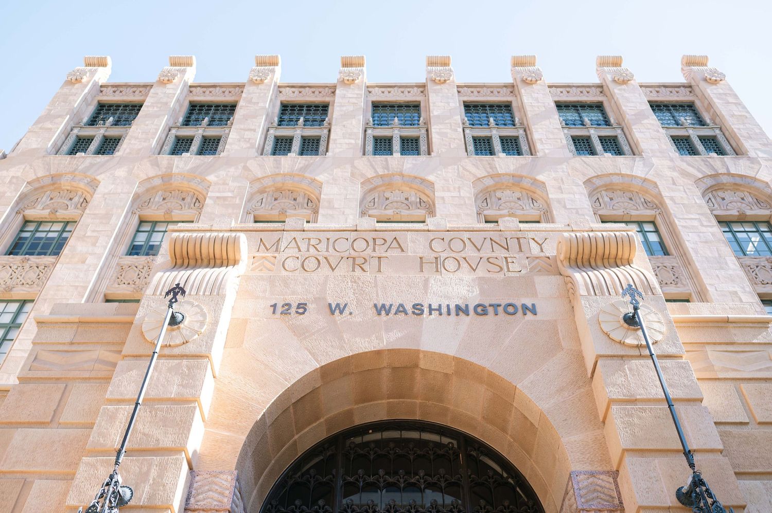 Historic stone building facade with ornate architectural details and arched entrance at 159 W Washington Street.
