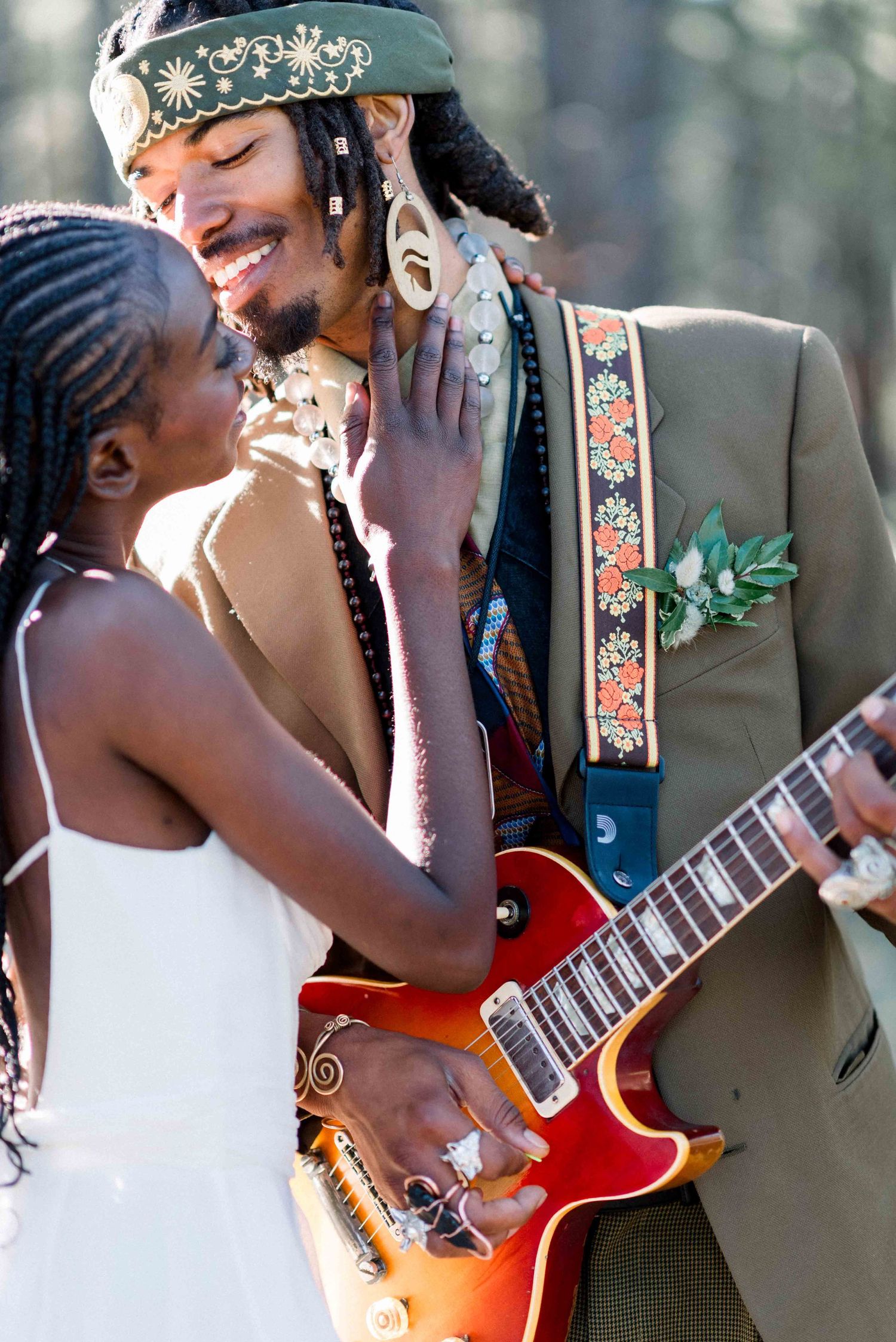 A joyful wedding moment with the bride and groom sharing an intimate moment as he holds an electric guitar.