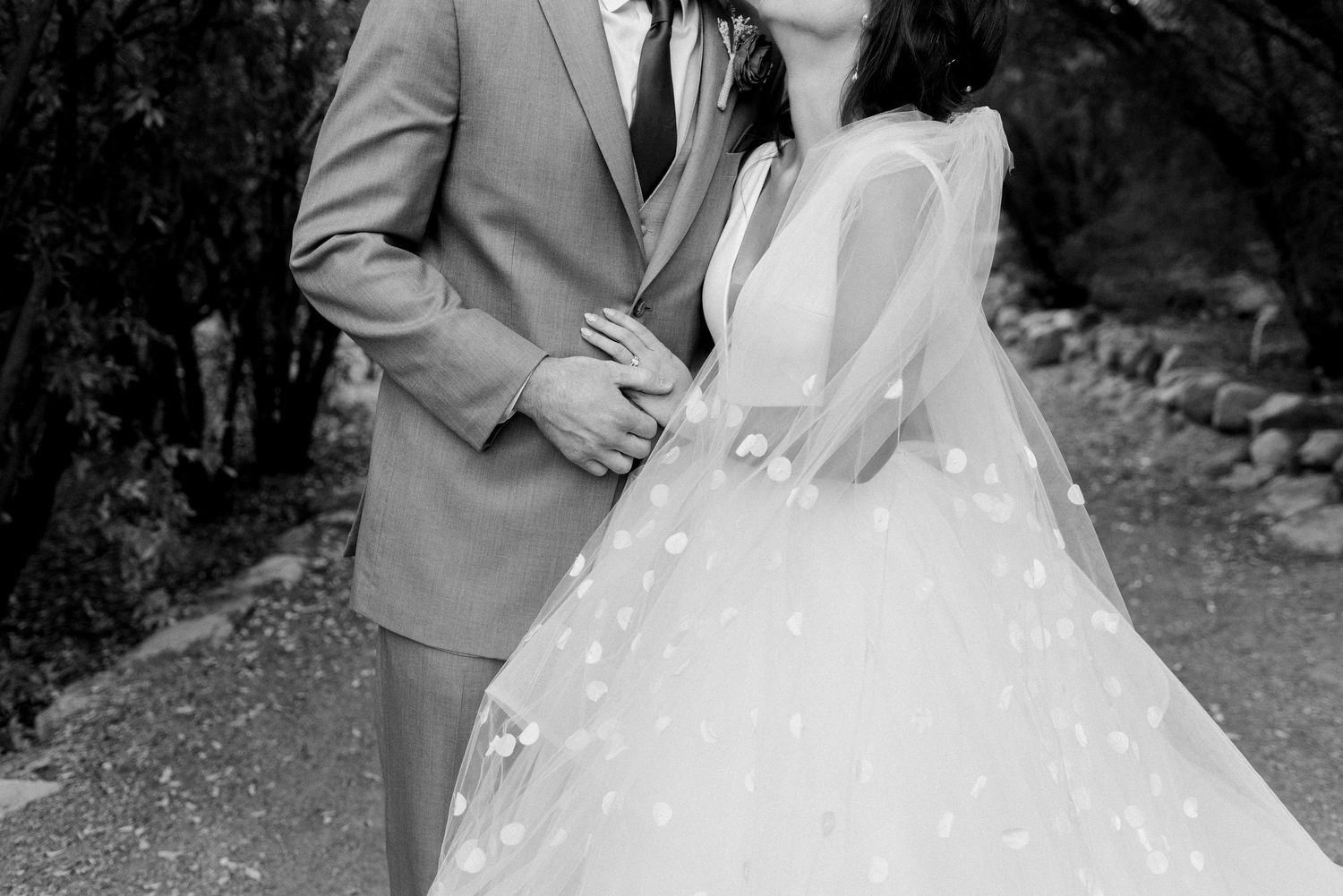 Black and white wedding portrait with soft natural lighting and delicate lace details.