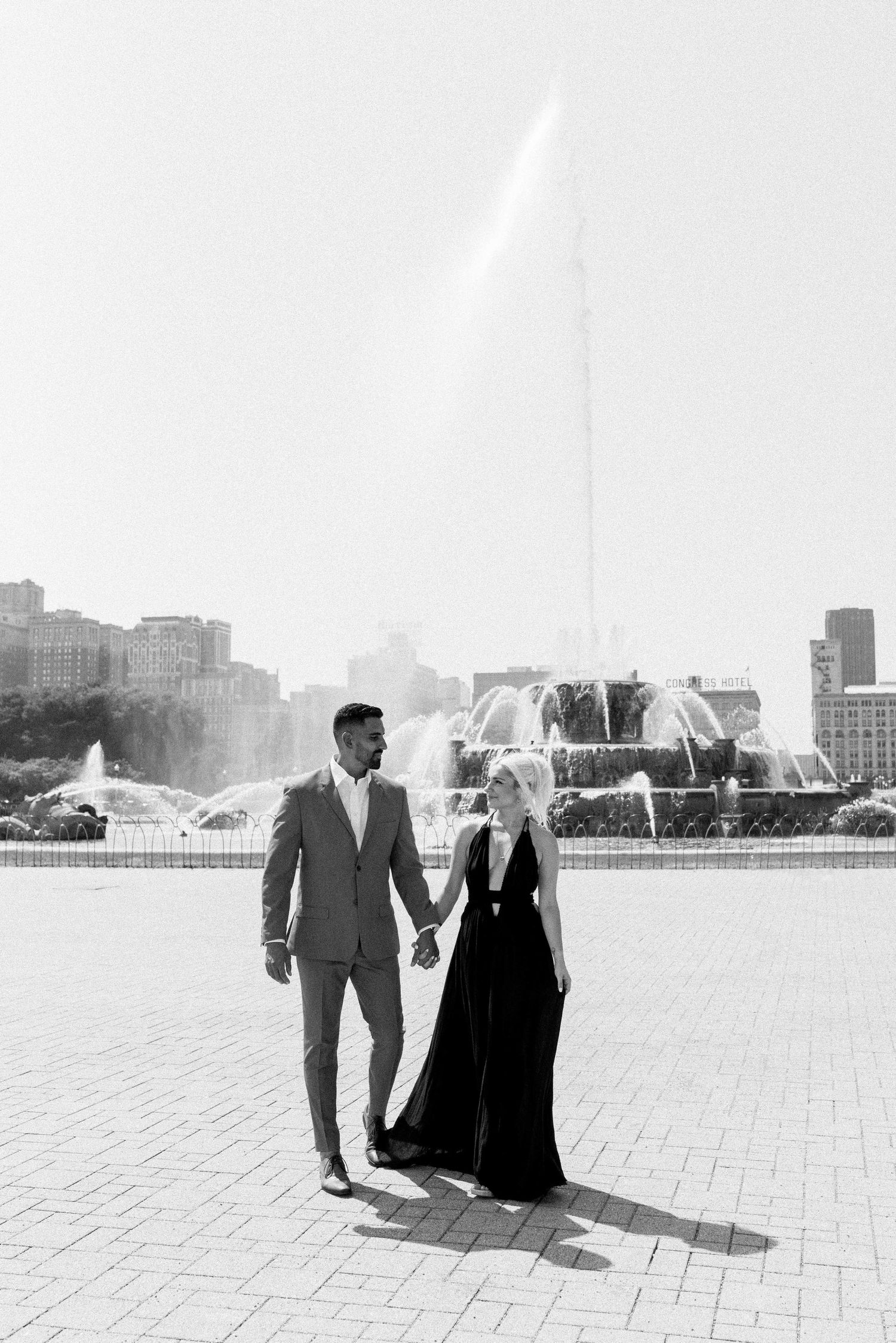 Couple in formal attire standing by Buckingham Fountain in Chicago's Grant Park.