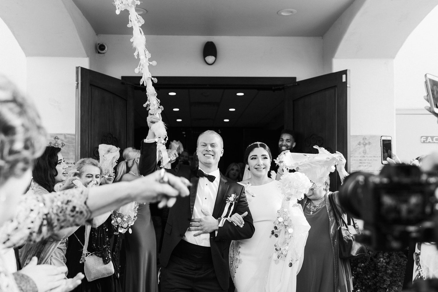 A black and white photo series capturing joyful celebration moments at a wedding reception.