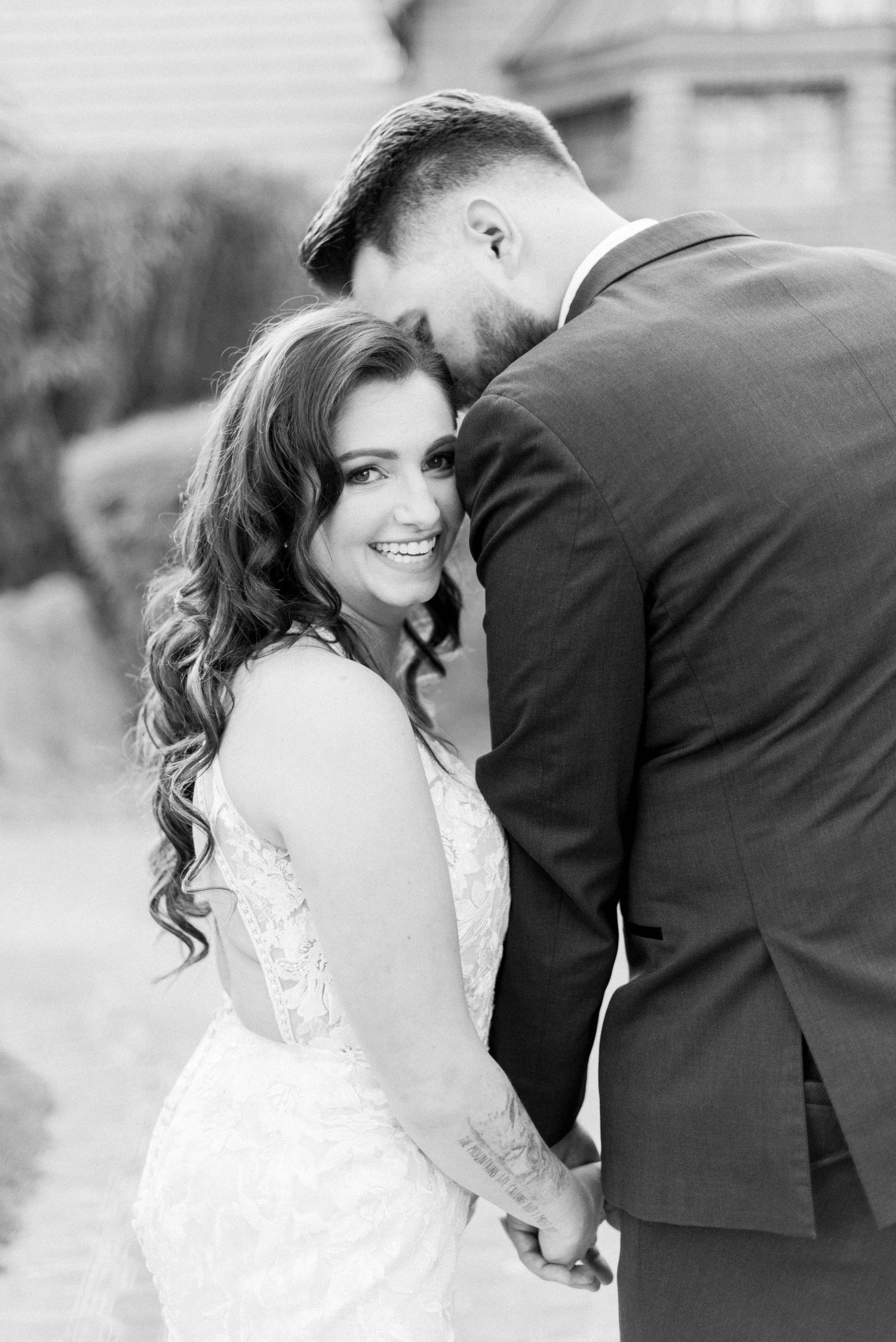 Intimate black and white portrait of newlyweds sharing a romantic moment.