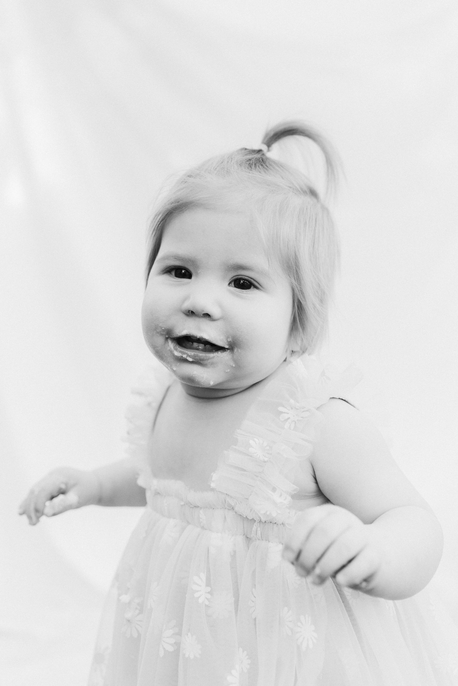 High-key black and white portrait series with soft lighting and white background.