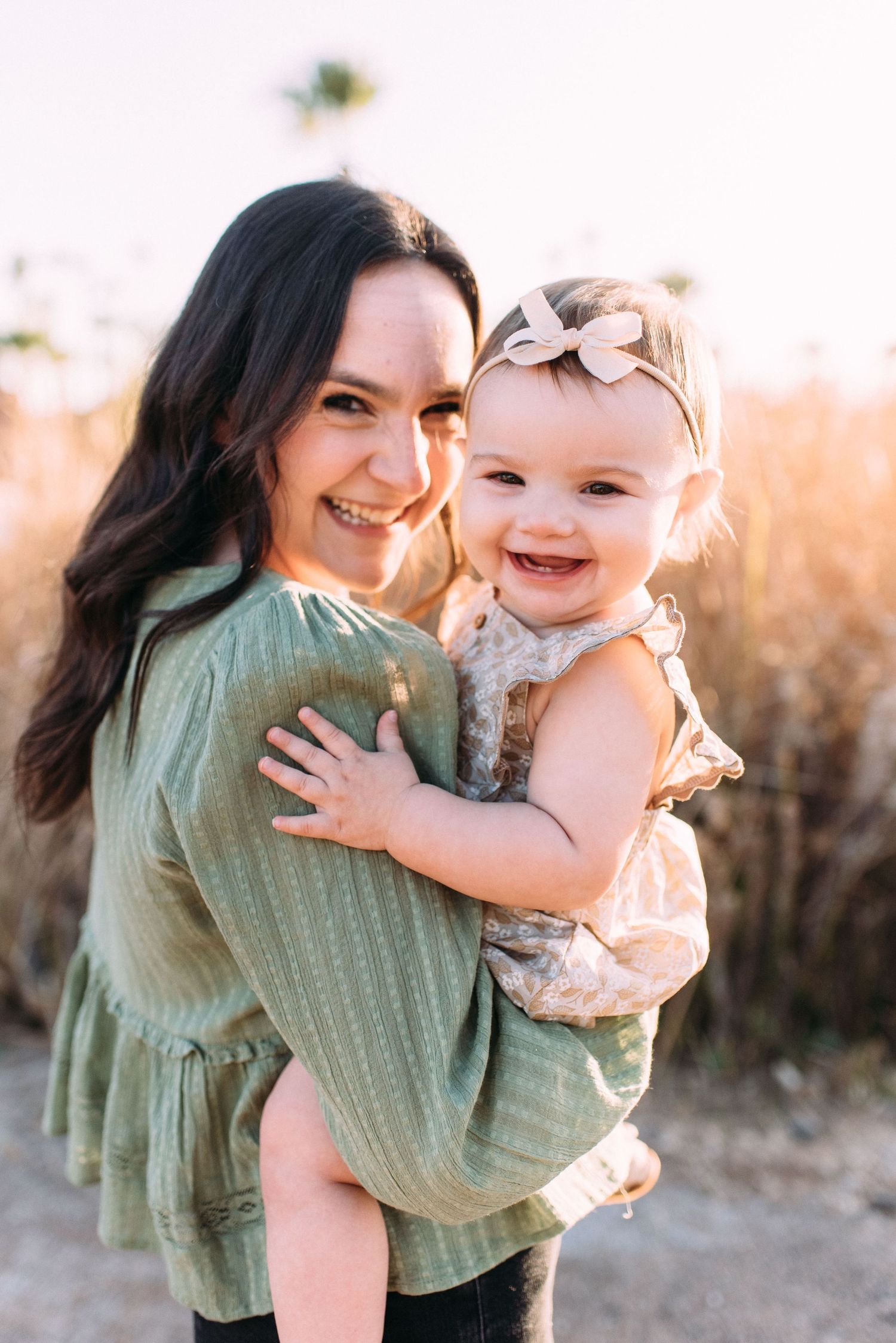 Candid outdoor portrait capturing joyful moments in warm sunlight.