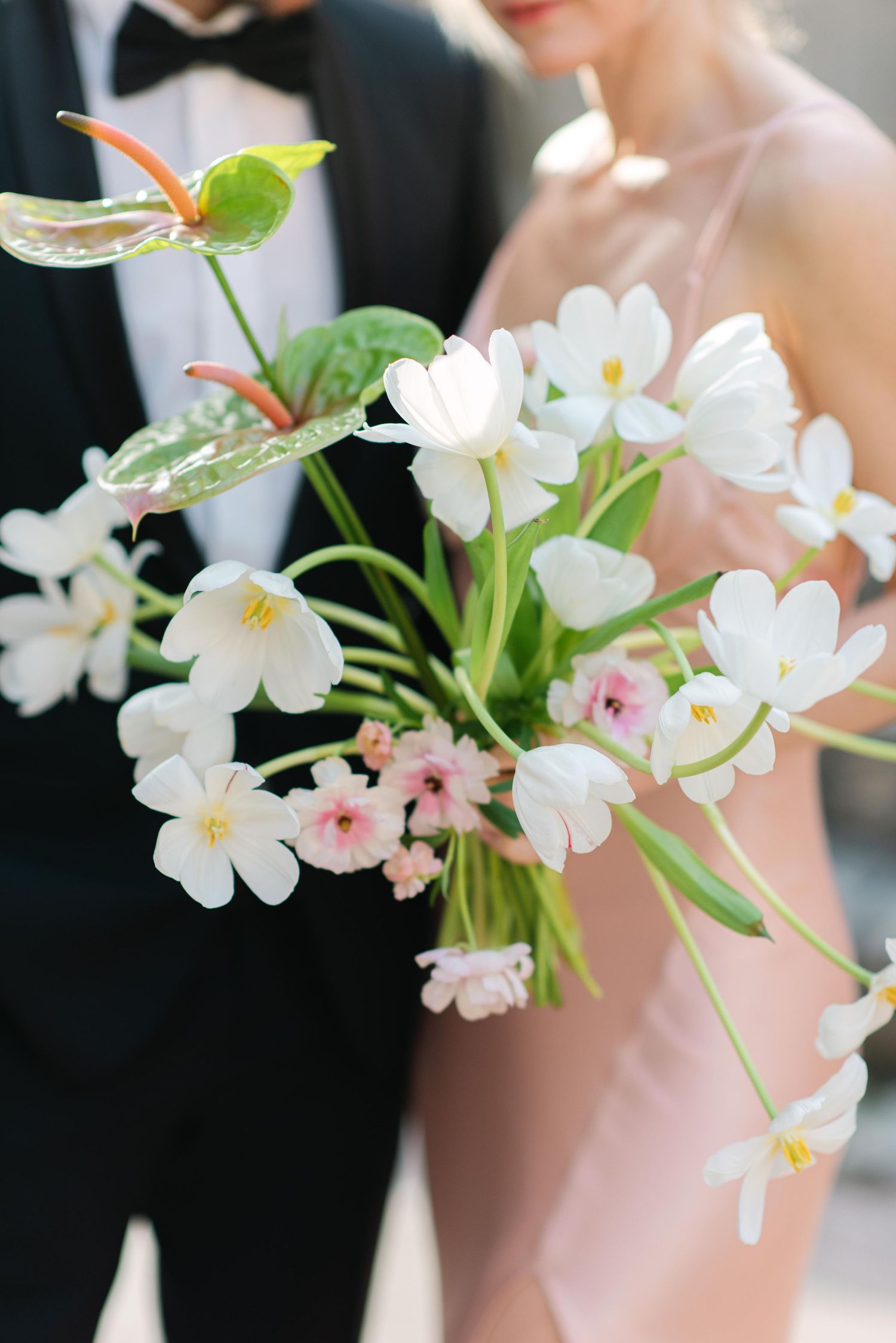 Delicate white and pink cherry blossoms arranged in an elegant floral display.