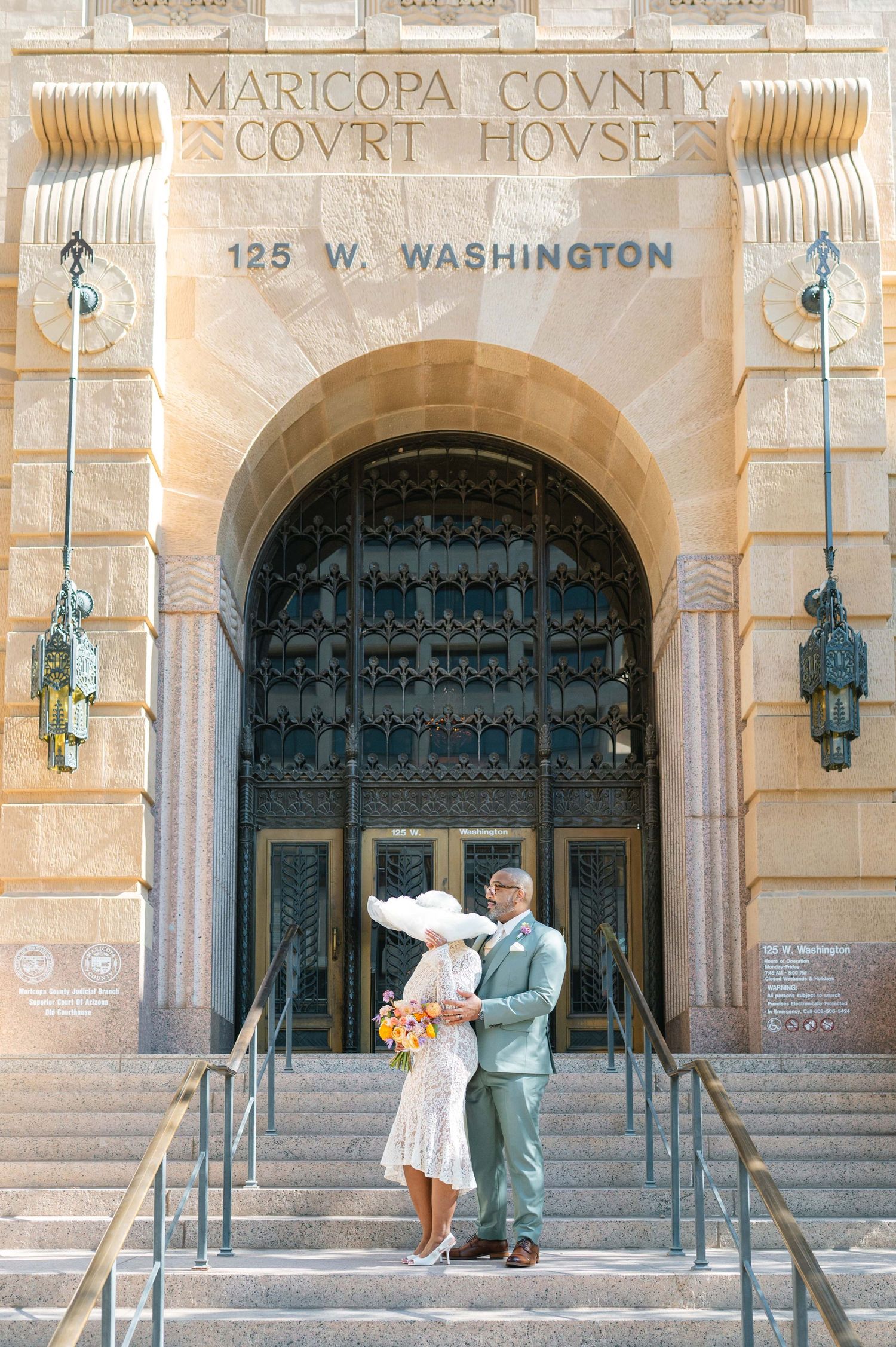 A couple dances in front of the ornate entrance to the historic Maricopa County Courthouse.