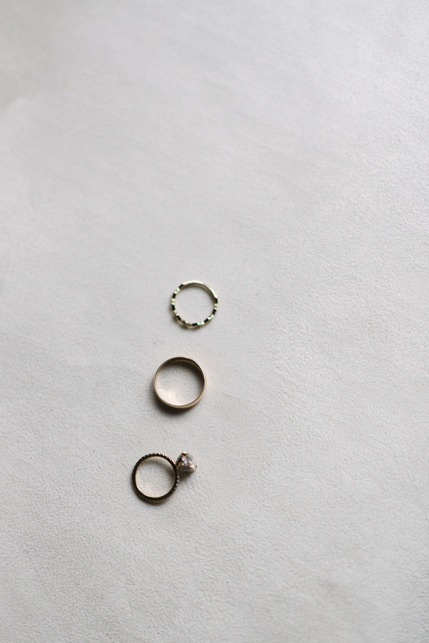 Minimalist photo of wedding rings on white background.