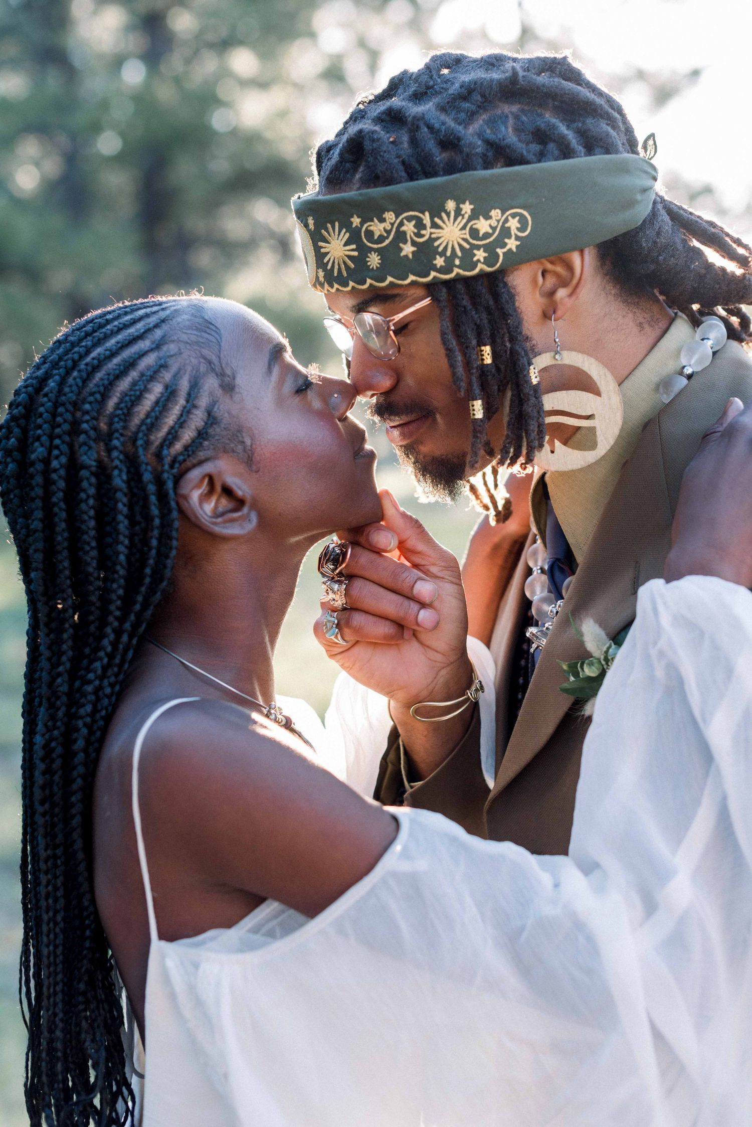Intimate wedding moment captured with beautiful natural bokeh background and close framing.