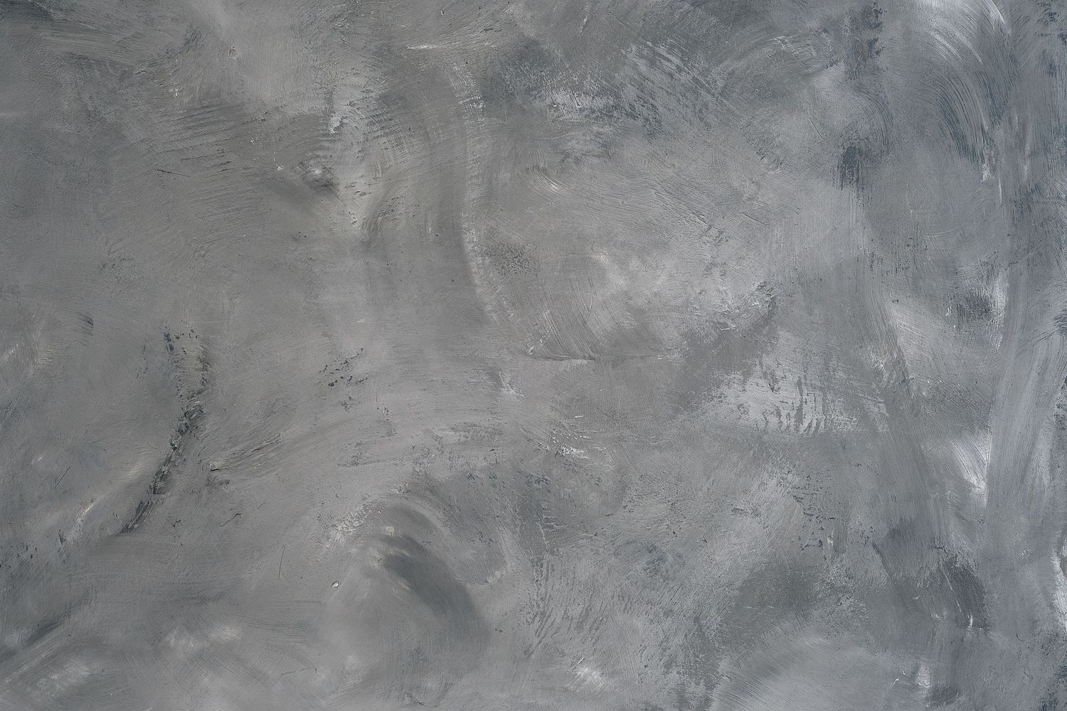 Abstract gray textured background with swirling brushstroke patterns and mottled surface effects.