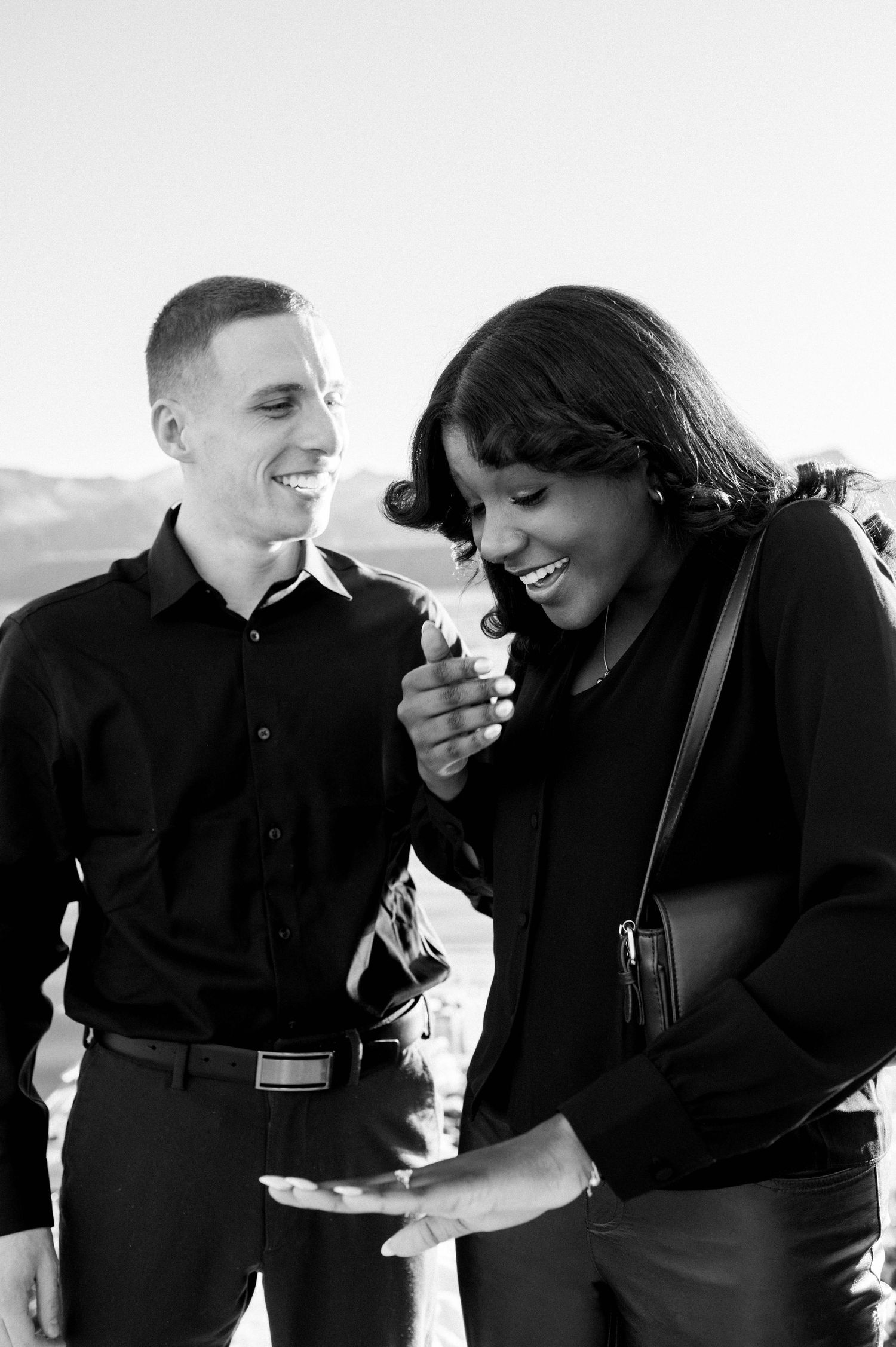 Black and white candid photos capturing joyful laughter and intimate moments.