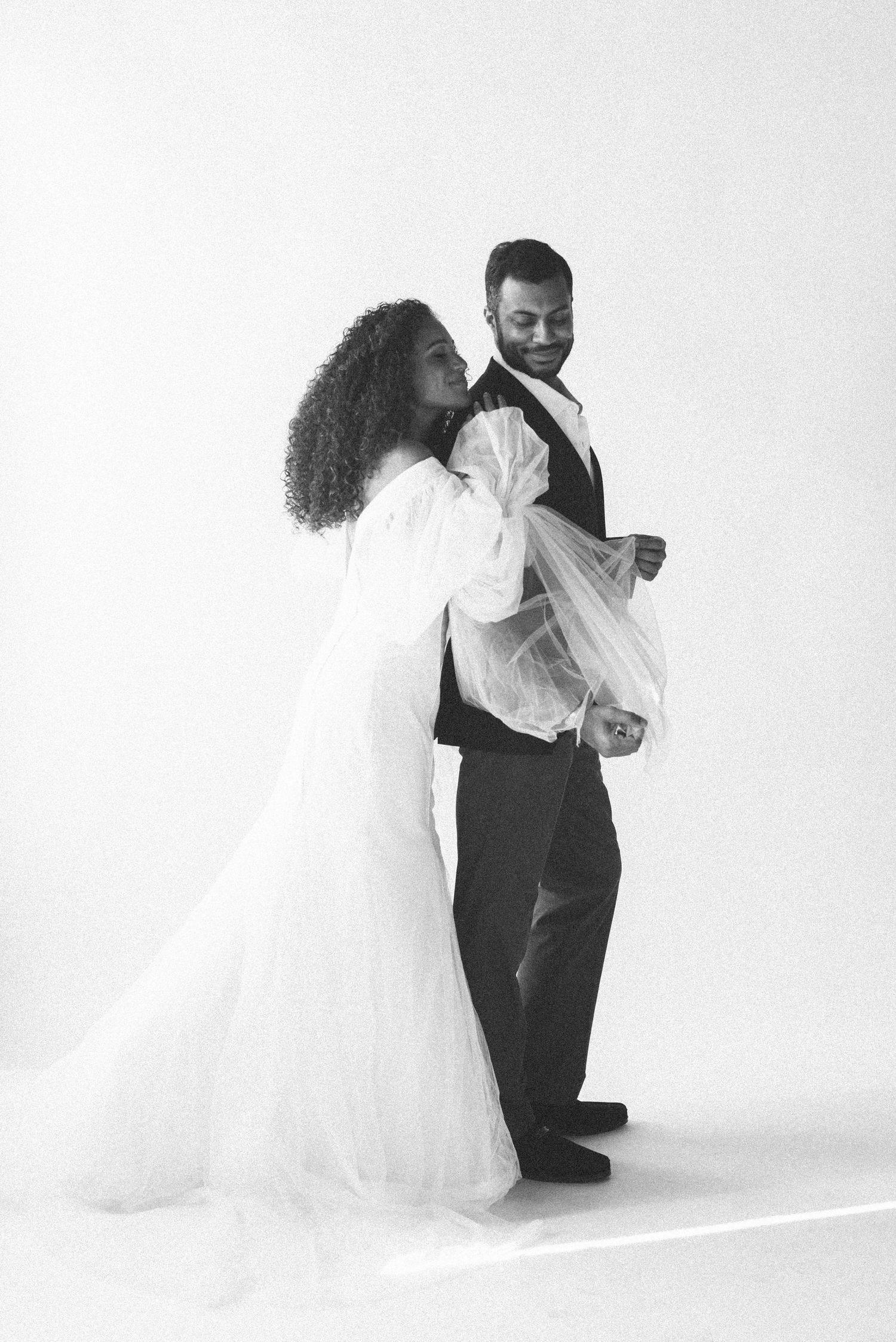 Black and white artistic wedding portrait showing candid movement and joy.